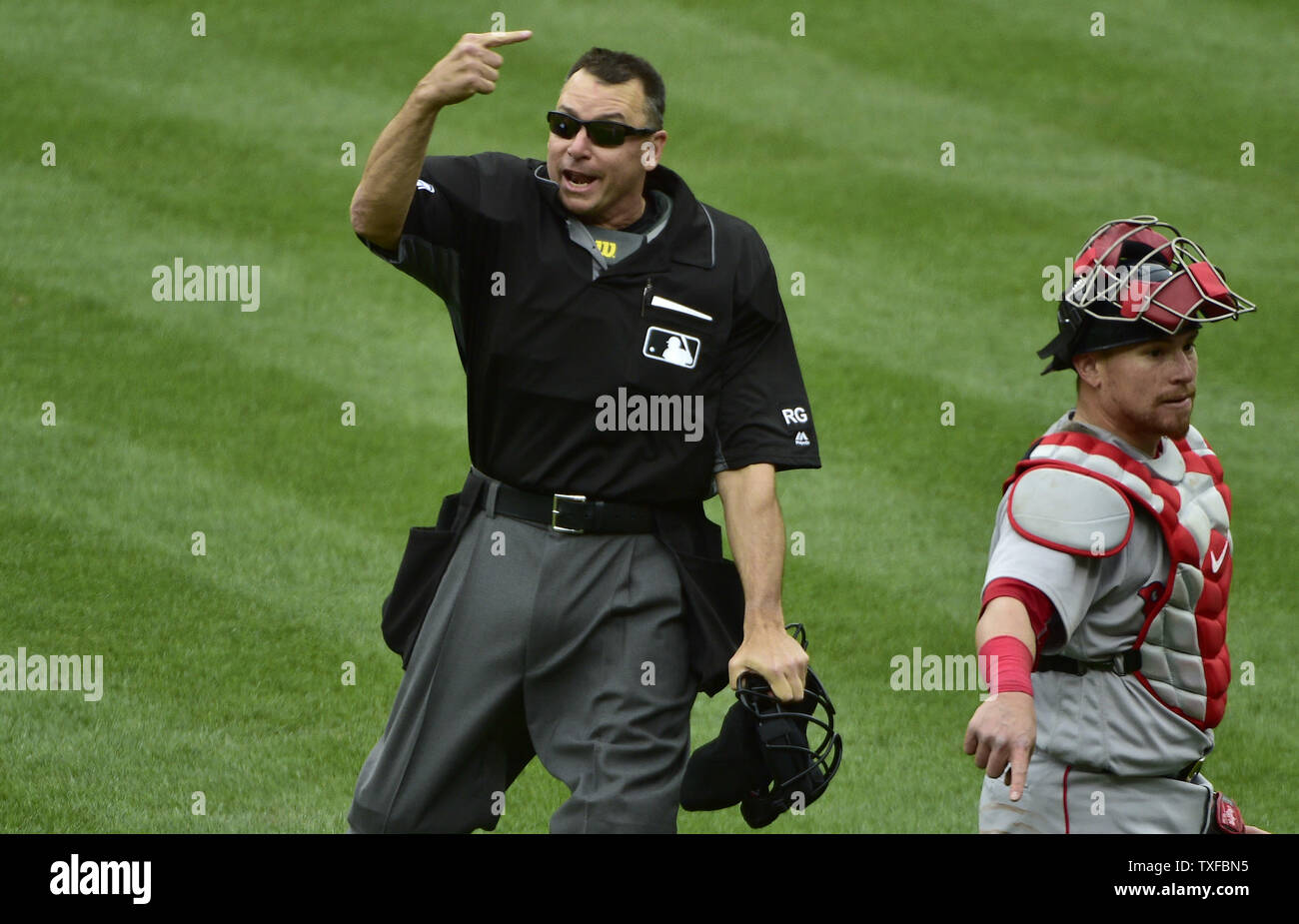 Home plate umpire Andy Fletcher signals the ejection of Boston Red Sox relief pitcher Matt Barnes after Baltimore Orioles' Manny Machado dodged a high pitch that hit his bat during the eighth inning at Camden Yards in Baltimore, April 23, 2017. Red Sox catcher Christian Vazquez (R) walks to the plate. Photo by David Tulis/UPI Stock Photo