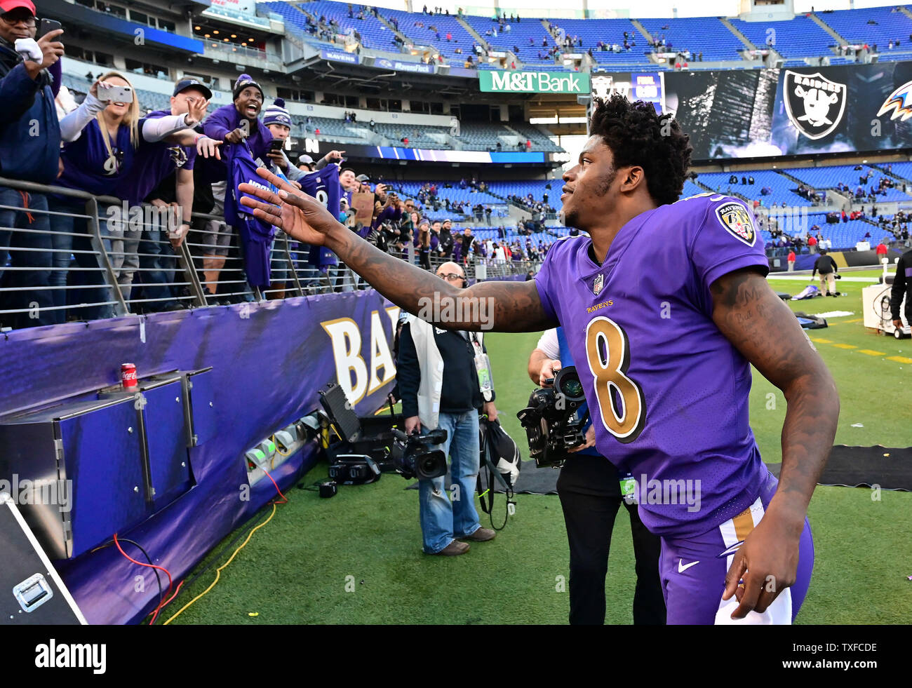 Baltimore Ravens quarterback Lamar Jackson (8) greets fans after