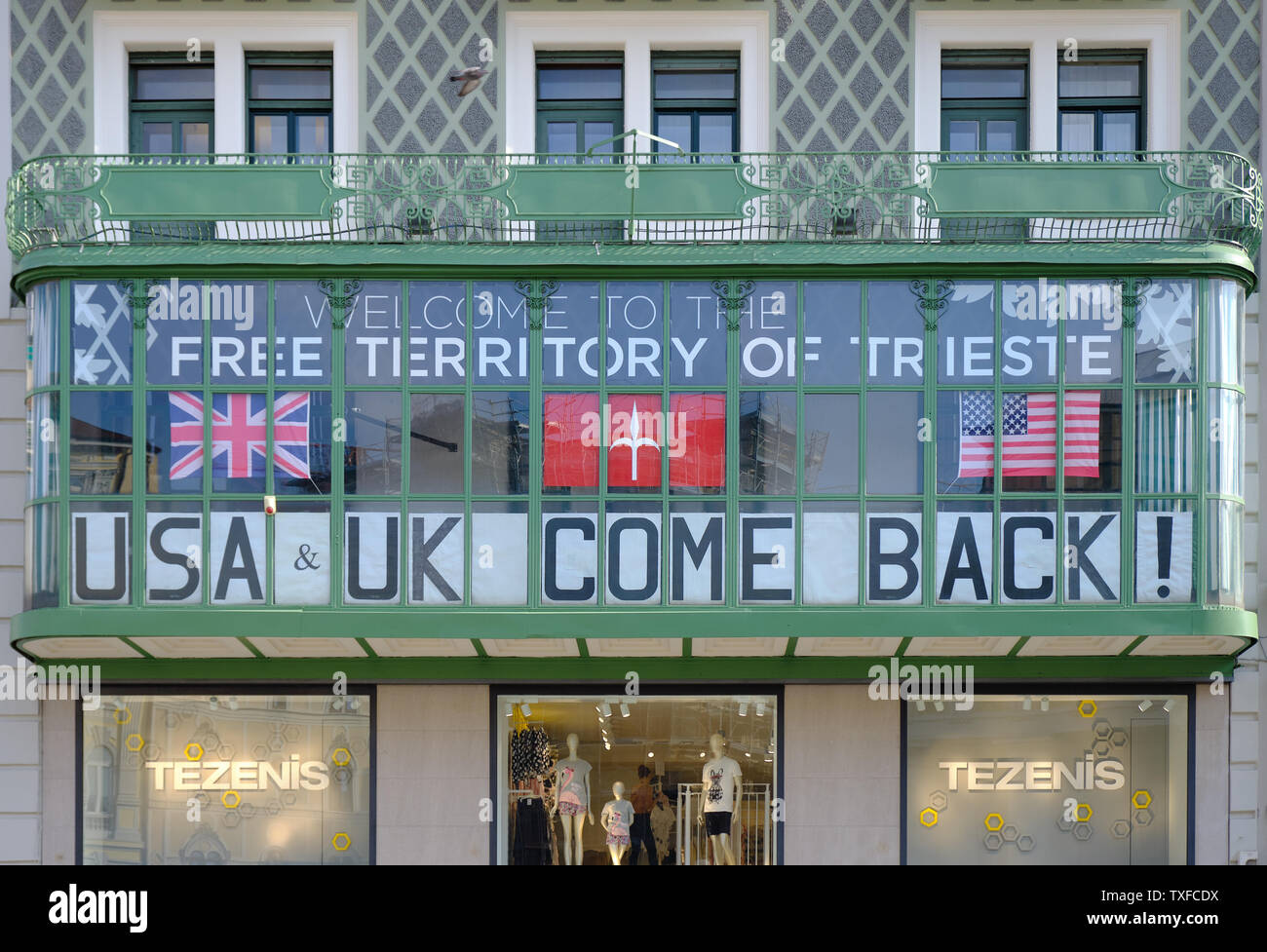 Banner in Window proclaiming 'Welcome to the Free Territory of Trieste', 'USA & UK come back!' . Trieste, Italy 2019 Stock Photo