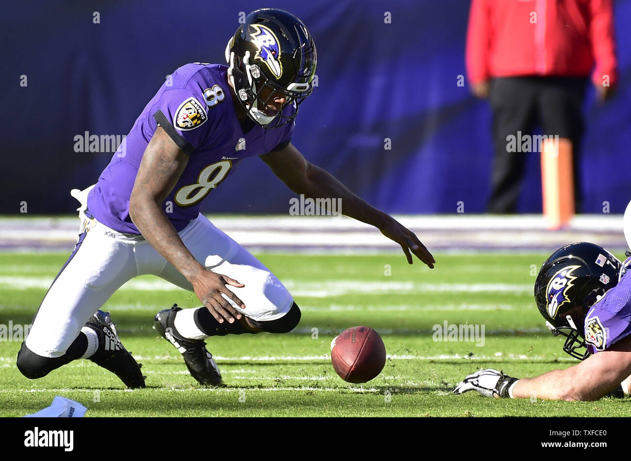 Baltimore Ravens quarterback Lamar Jackson (8) recovers his own fumble ...