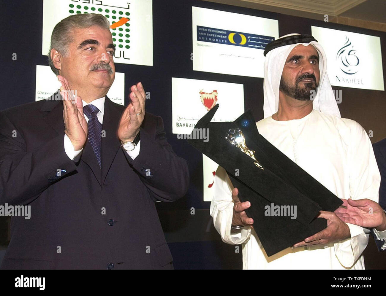 Lebanese Prime Minister Rafic Hariri, left, honors Crown Prince of Dubai and UAE Defense Minister Sheikh Mohammed Bin Rashid al Maktoum (right) and offers him an award at the opening session of the 10th  Arab Investment and Capital markets Conference in Beirut Thursday morning June 24, 2004. The two-day conference attracted nearly 1,000 participants, including former Malaysian Prime Minister Mahathir Mohamad.  (UPI Photo/Mohammed Tawil) Stock Photo
