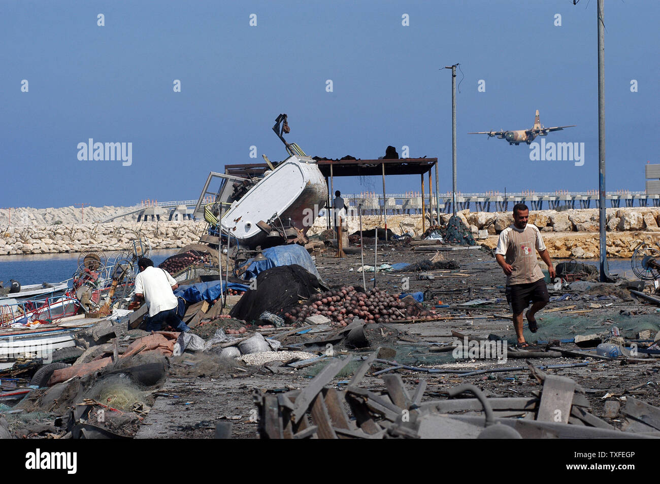 A day after Israelis bombed a small fishing port in Ouzai, in Beirut's southern suburbs, fishermen return to see what they can salvage from their boats on August 5, 2006. The Israeli Air Force continues to target what's left of Beirut's southern suburbs three weeks into the their air campaign. Lebanese officials estimate over 650 Lebanese, mostly civilians, have died since July 12, 2006.  (UPI Photo/ Norbert Schiller) Stock Photo