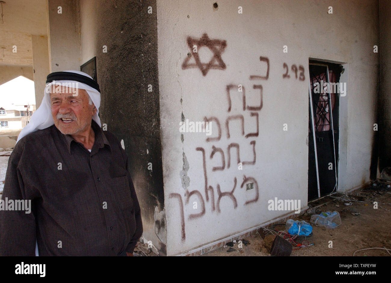 A Lebanese man returning home to the border village of Maroun Er Ras ...