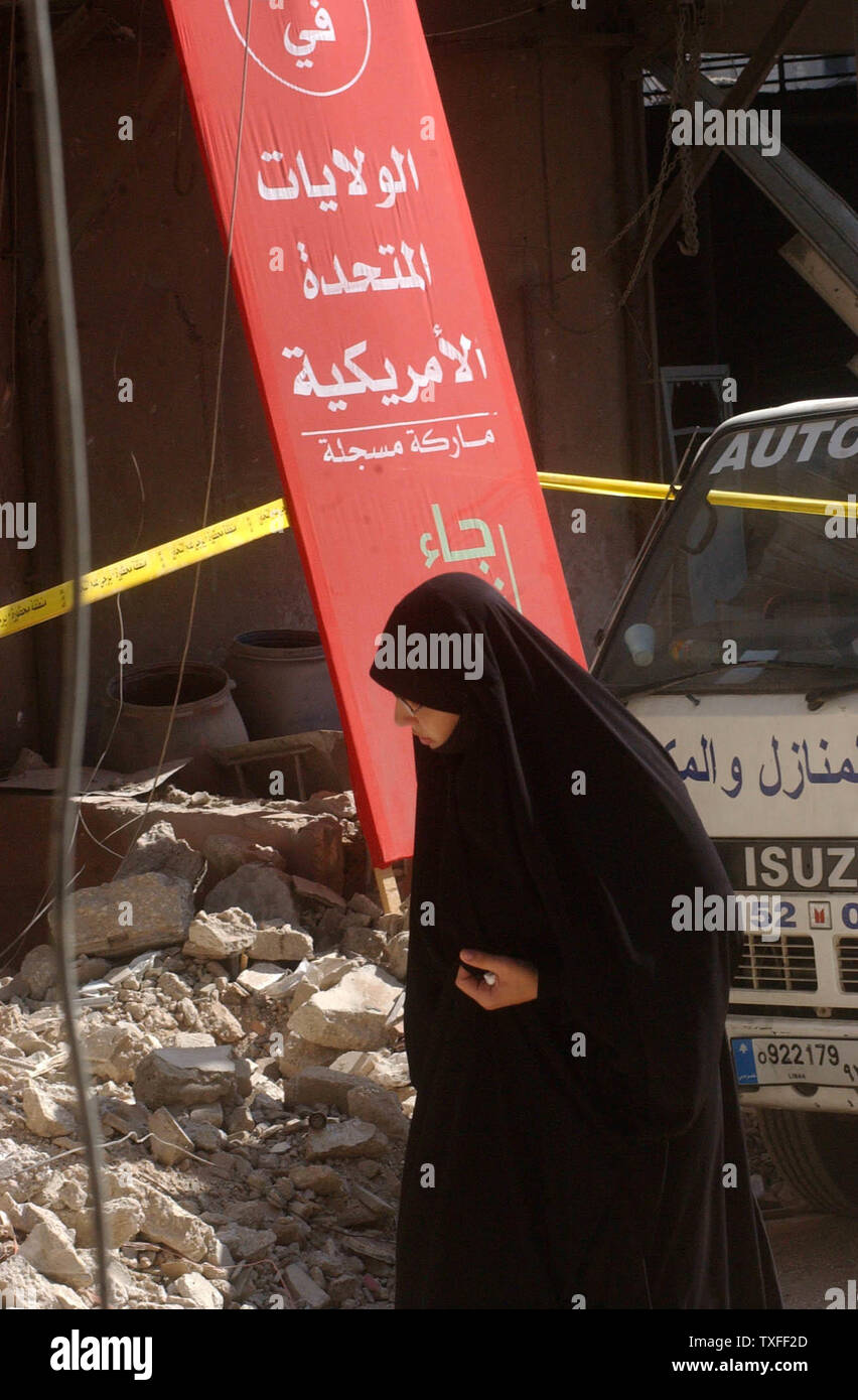 A veiled woman passes Hezbollah propaganda in of Beirut's southern suburbs on August 24, 2006. The Hezbollah organization is paying people who have lost property a stipend to relocate until their own home can be rebuilt. (UPI Photo) Stock Photo