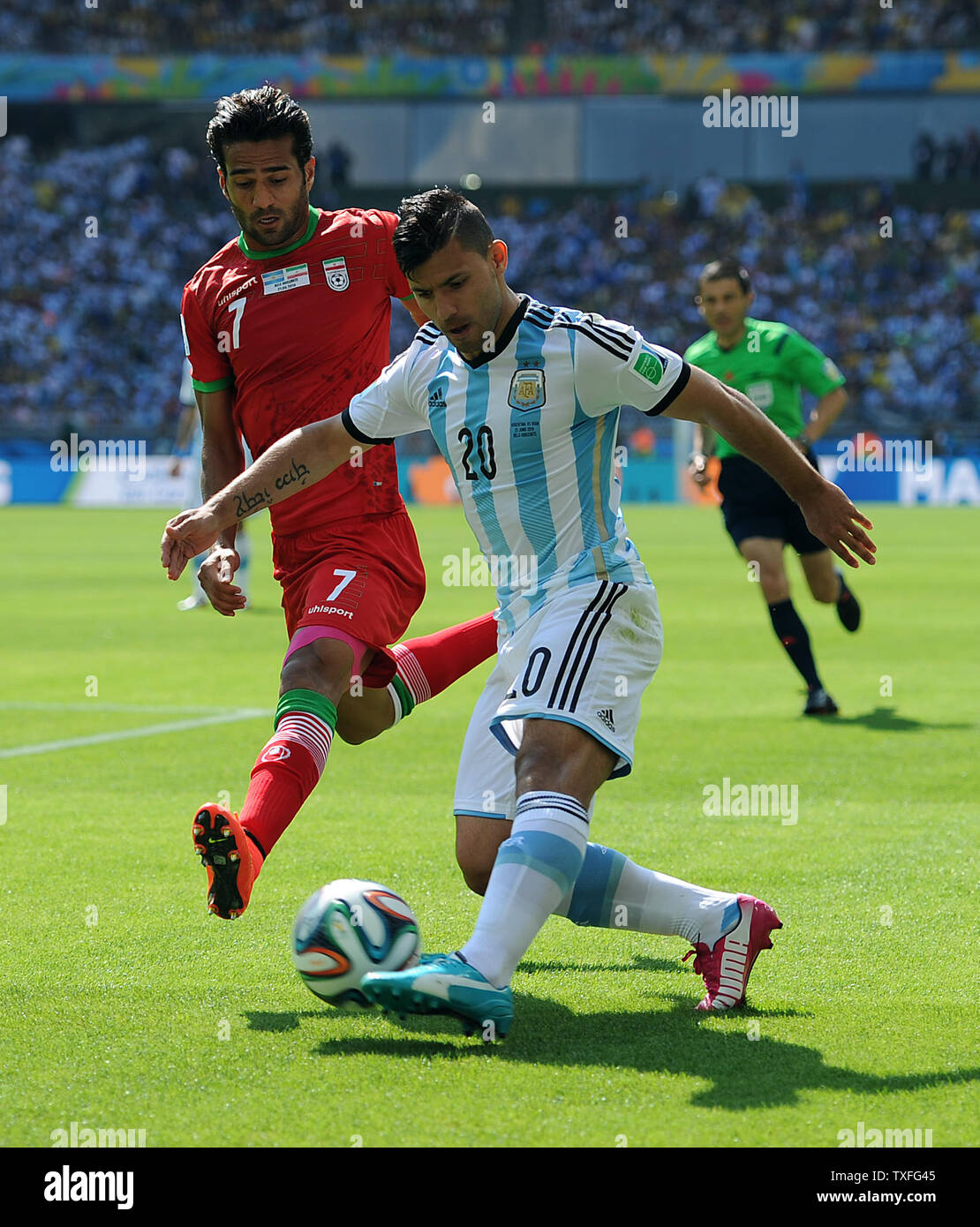 Sergio Aguero of Argentina competes with Masoud Shojaei (L) of Iran during the 2014 FIFA World Cup Group F match at the Estadio Mineirao in Belo Horizonte, Brazil on June 21, 2014. UPI/Chris Brunskill Stock Photo