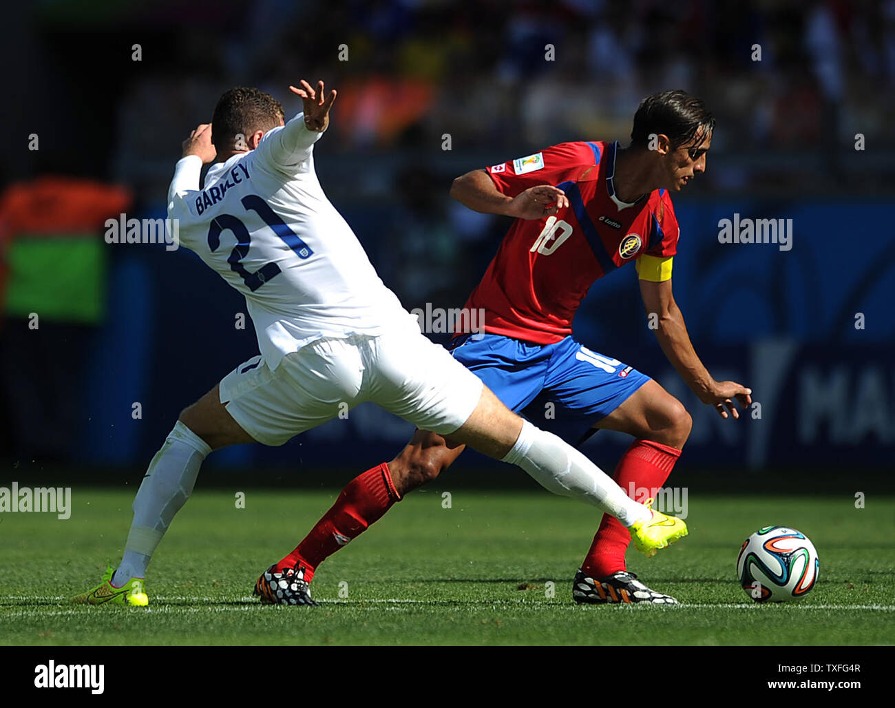 Bryan Ruiz of Costa Rica evades Ross Barkley (L) of England during the 2014 FIFA World Cup Group D match at the Estadio Mineirao in Belo Horizonte, Brazil on June 24, 2014. UPI/Chris Brunskill Stock Photo