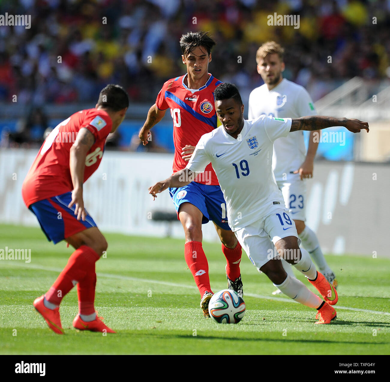 Bryan Ruiz (C) of Costa Rica chases Raheem Sterling of England during the 2014 FIFA World Cup Group D match at the Estadio Mineirao in Belo Horizonte, Brazil on June 24, 2014. UPI/Chris Brunskill Stock Photo