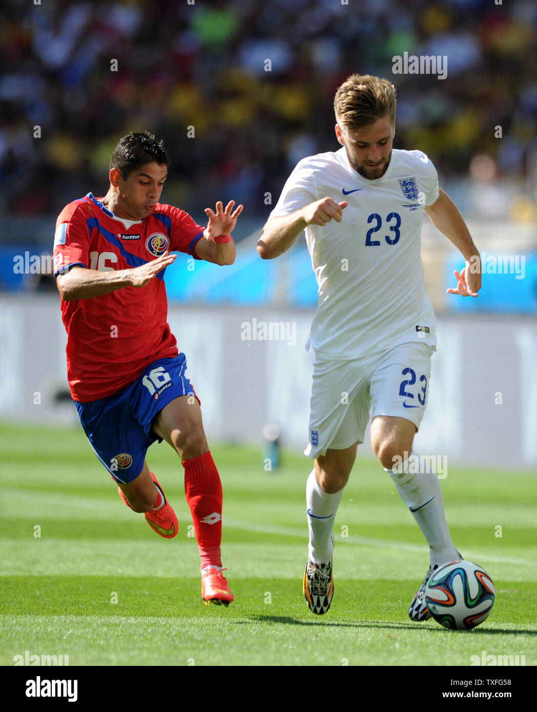 Cristian Gamboa (L) of Costa Rica chases Luke Shaw of England during the 2014 FIFA World Cup Group D match at the Estadio Mineirao in Belo Horizonte, Brazil on June 24, 2014. UPI/Chris Brunskill Stock Photo