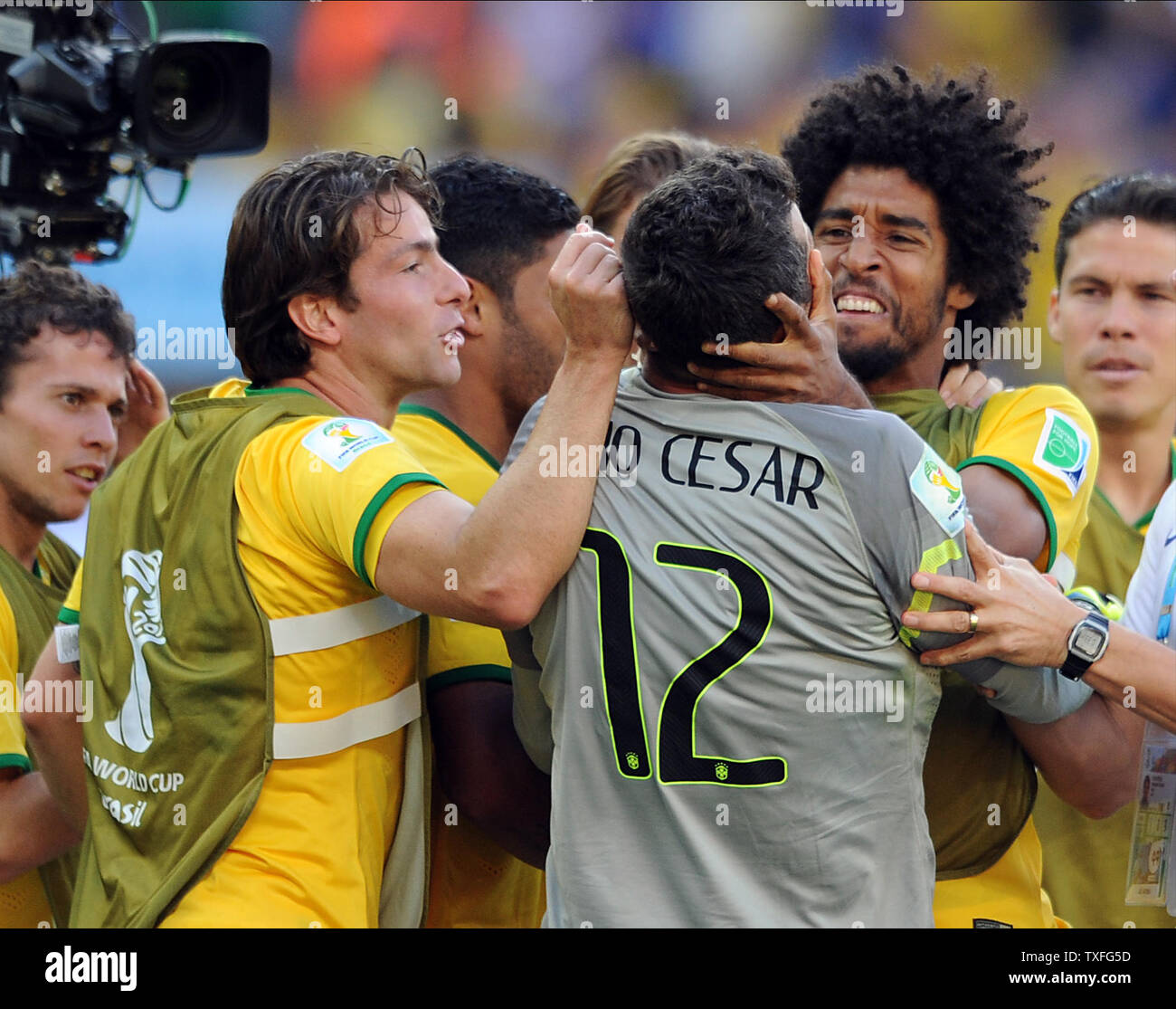 Julio Cesar of Brazil is congratulated by team-mate Dante following the 2014 FIFA World Cup Round of 16 match at the Estadio Mineirao in Belo Horizonte, Brazil on June 28, 2014. UPI/Chris Brunskill Stock Photo