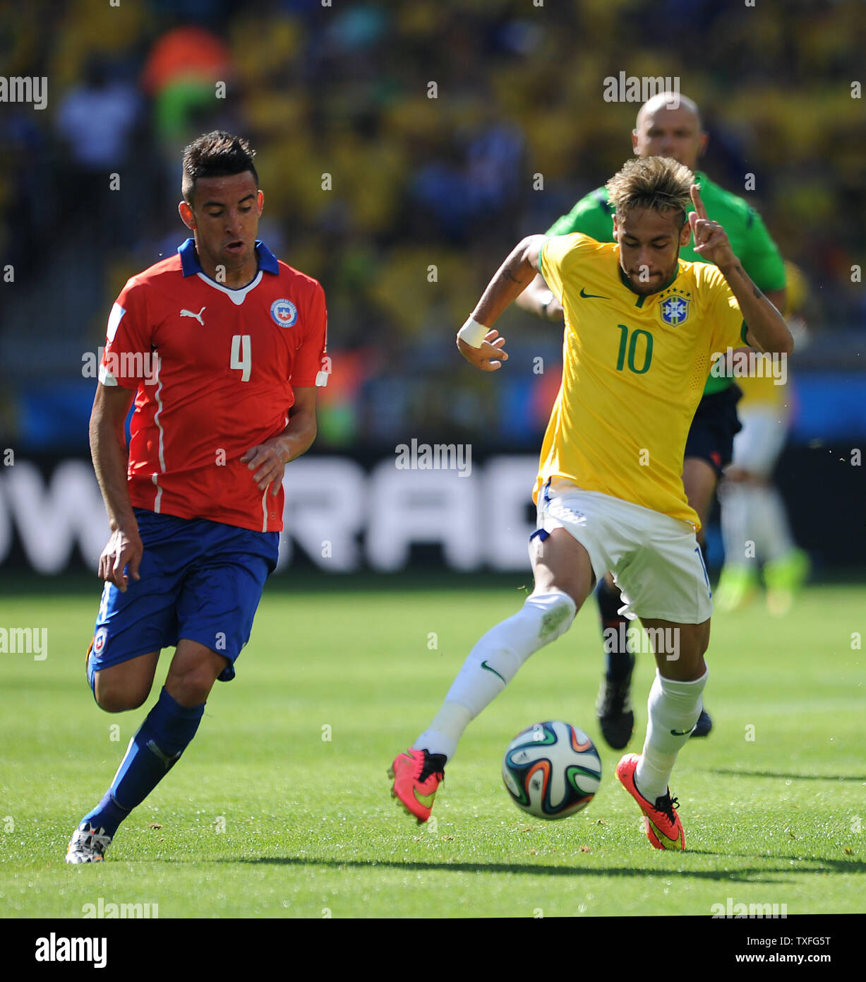 Neymar of Brazil competes with Mauricio Isla (L) of Chile during the 2014 FIFA World Cup Round of 16 match at the Estadio Mineirao in Belo Horizonte, Brazil on June 28, 2014. UPI/Chris Brunskill Stock Photo