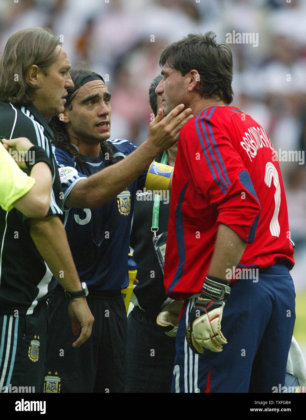 Argentina's goal keeper Roberto Abbondanzieri  is remontivated by his team players to continue but had to resign soon afterwards due to injury during World Cup soccer at Olympiastadion on Friday, June 30, 2006 in Berlin, Germany. Germany defeated Argentina 4-2.   (UPI Photo/Arthur Thill) Stock Photo