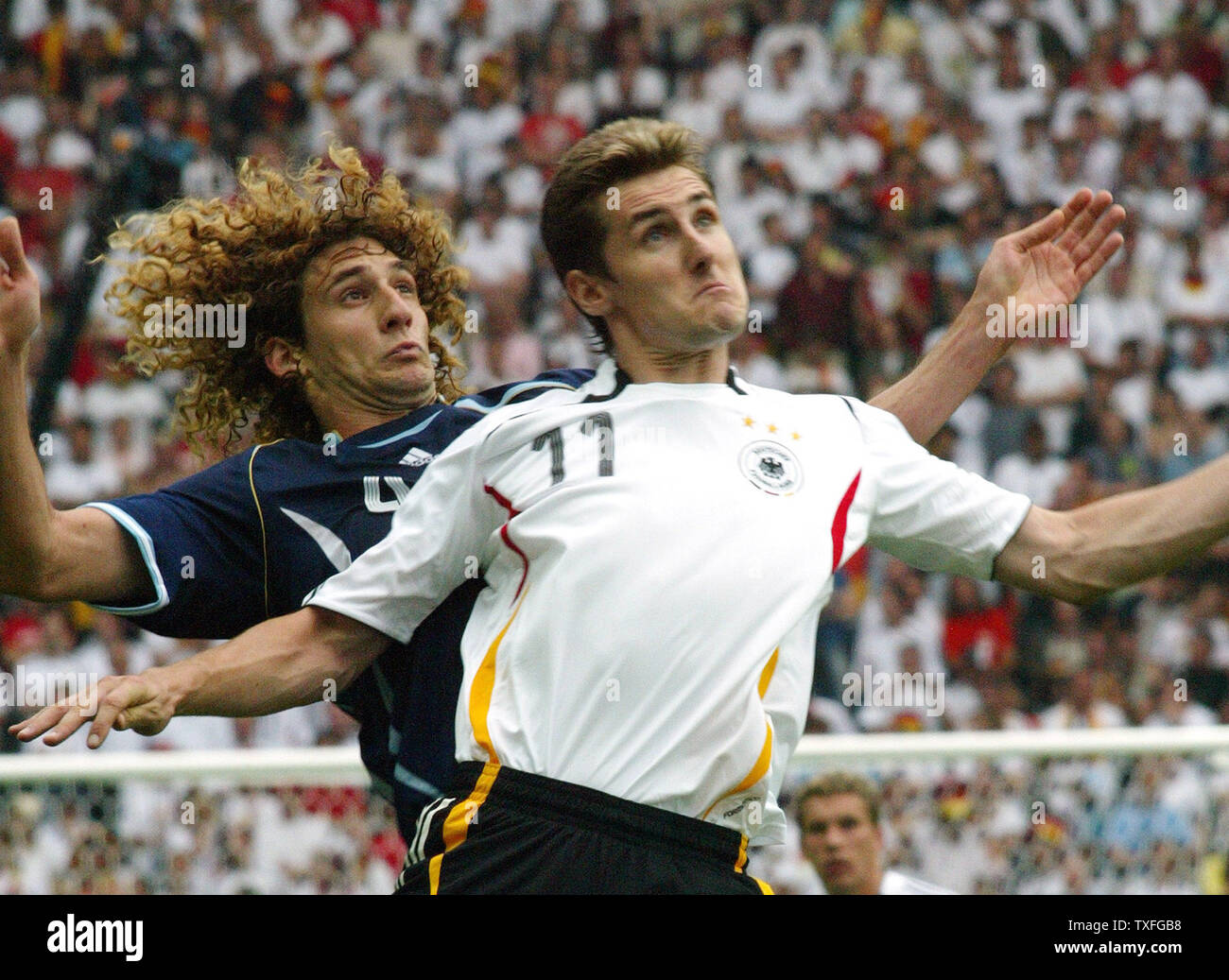 Miroslav Klose of Germany (11) and Argentina's Fabricio Coloccini (4) try and get the head on the ball during World Cup soccer at Olympiastadion on Friday, June 30, 2006. Germany defeated Argentina 4-2.   (UPI Photo/Arthur Thill) Stock Photo