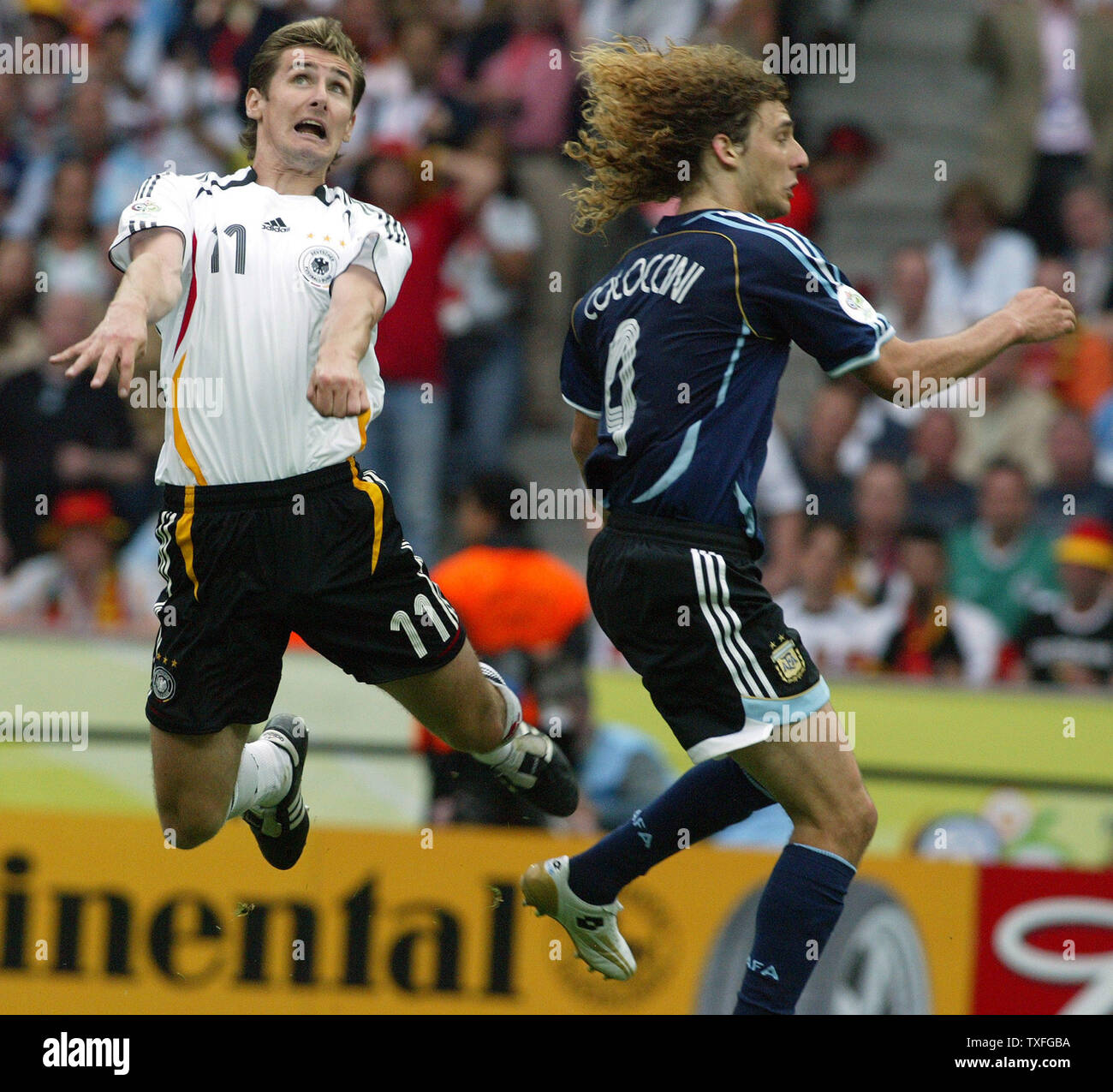 Miroslav Klose of Germany (11) heads the ball against Argentina's Fabricio Coloccini (4) during World Cup soccer at Olympiastadion on Friday, June 30, 2006 in Berlin, Germany. Germany defeated Argentina 4-2.   (UPI Photo/Arthur Thill) Stock Photo