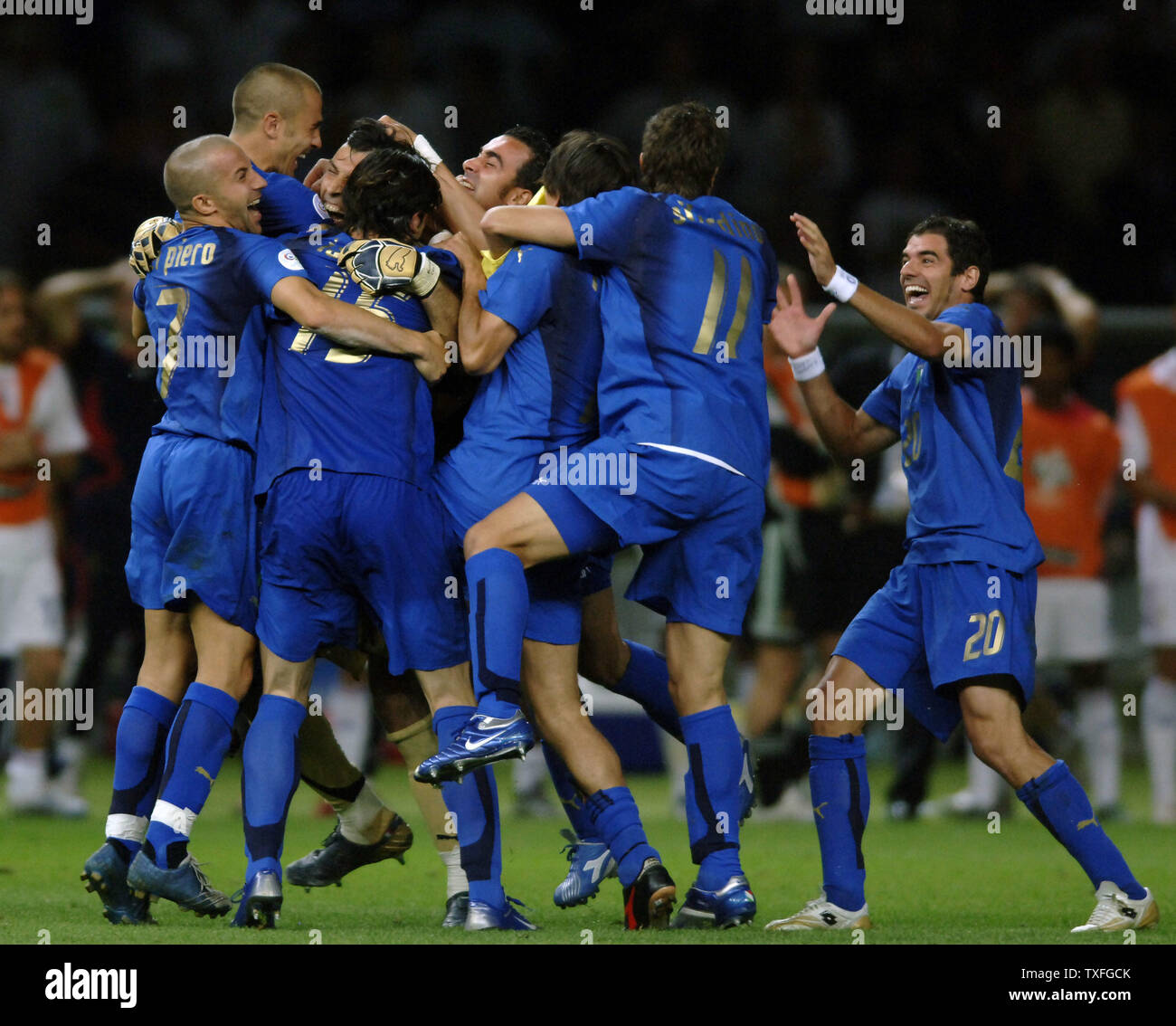 Italian players Simone Perrotta (20), Alberto Gilardino (11), Alessandro del Piero (7) and Vincenzo Iaquinta (15) jump on keeper Gianluigi Buffon (center) to celebrate the victory over France in the World Cup soccer final in Berlin, Germany on Sunday July 9, 2006.  Italy became World Champion  after a penalty shoot out edged France 5-3.   (UPI Photo/Thierry Gromik) Stock Photo