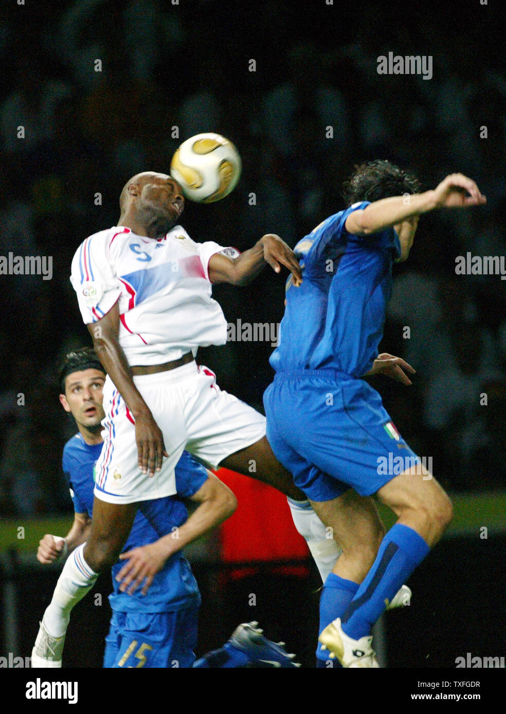 France's William Gallas (5) heads the ball against Italy's Vicenzo Iaquinta in the World Cup soccer final in Berlin, Germany on July 9, 2006. Italy is World Champion after defeating France 5-3. (UPI Photo/Arthur Thill) Stock Photo
