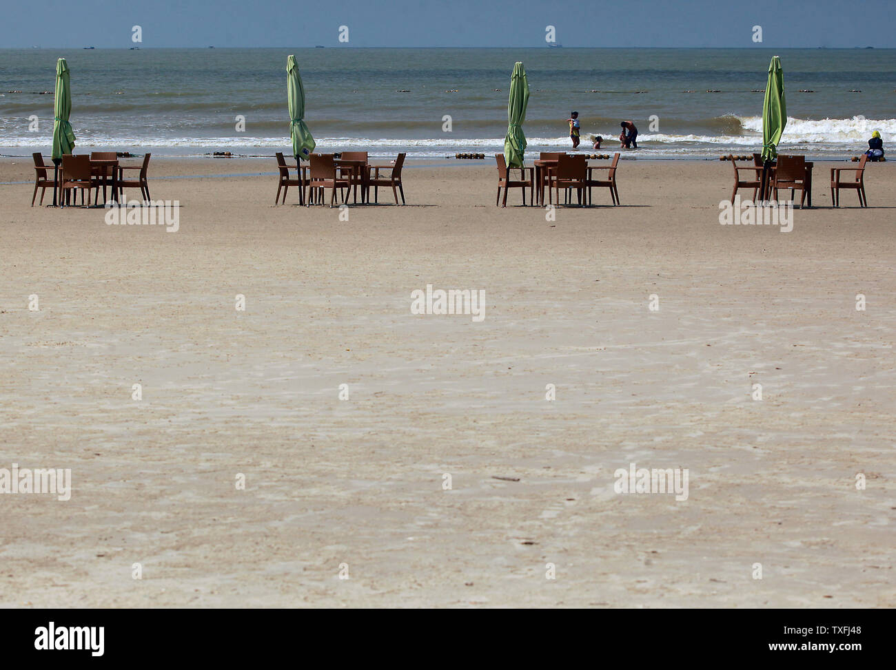 A Beach Side Restaurant Has Dining Tables On The Sand On Silver