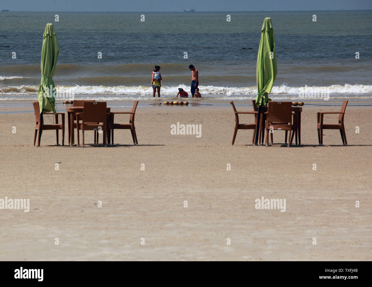 A Beach Side Restaurant Has Dining Tables On The Sand On Silver