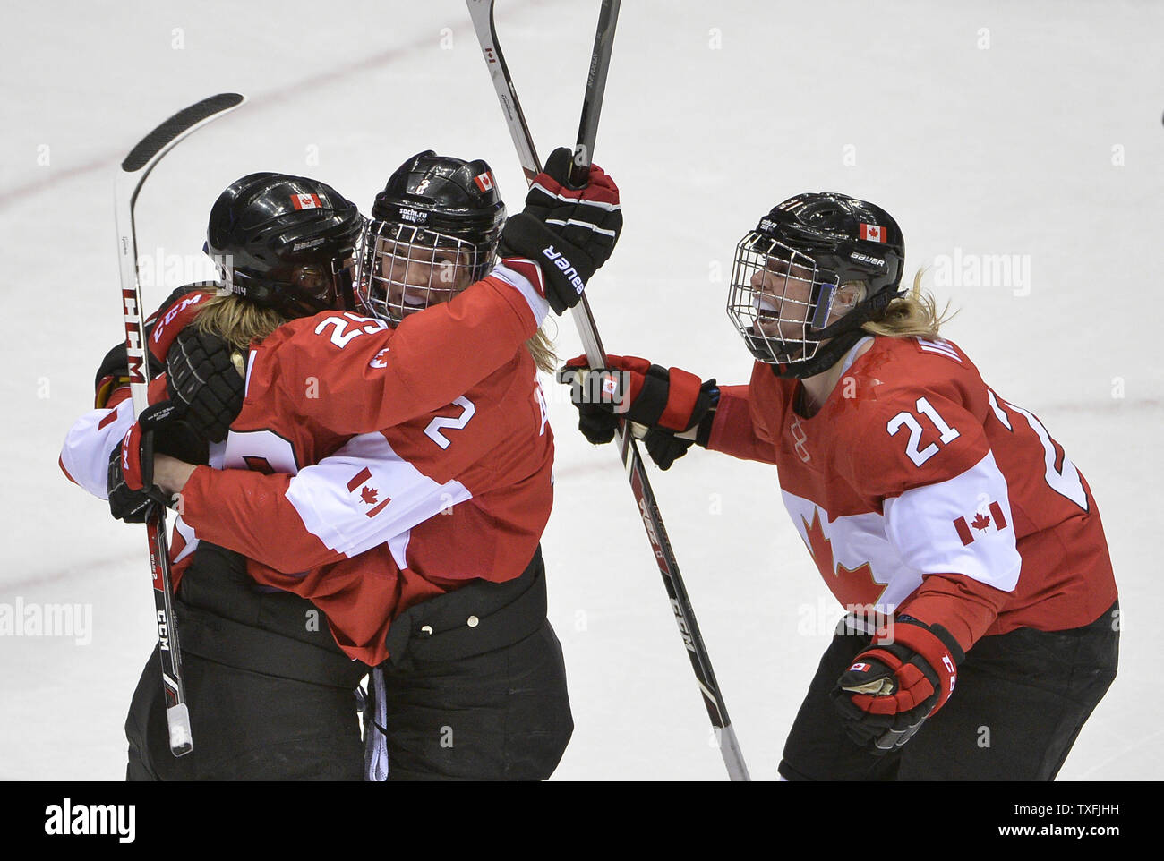 Canada's Marie-Philip Poulin (L-R), Meghan Agosta and Haley Irwin celebrate Poulin's goal during the third period of the women's gold medal ice hockey game against the United States at the Sochi 2014 Winter Olympics on February 20, 2014 in Sochi, Russia.     UPI/Brian Kersey Stock Photo