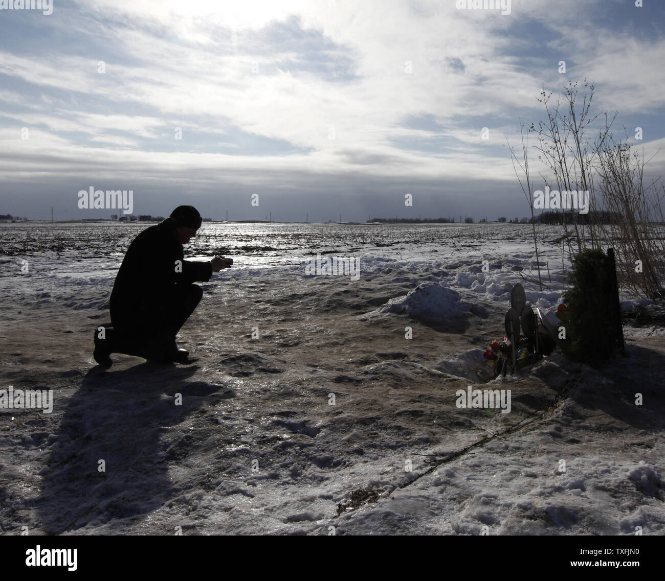 Brian Wilson of Toronto, Canada takes a photo of a memorial at the site of the plane crash that killed Buddy Holly, Ritchie Valens and J. P. 'The Big Bopper' Richardson near Clear Lake, Iowa on February 2, 2009. Singer Don McLean coined the phrase 'the day the music died' in his hit song American Pie referring to the death of the three rock 'n' roll pioneers in the early morning hours of February 3, 1959. Thousands of people descended upon Clear Lake to celebrate the 50th anniversary of 'the day the music died'.   (UPI Photo/Brian Kersey) Stock Photo