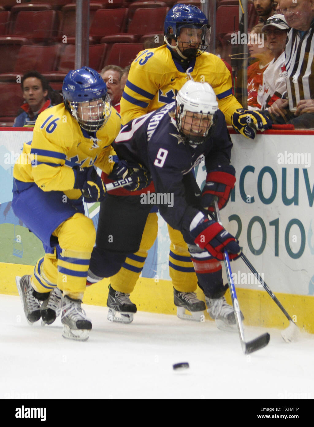 Molly Engstrom (9) skates with the puck as Pernilla Winberg (L) and Gunilla Andersson of Sweden defend during the second period of an ice hockey game at the 2010 Winter Olympics in Vancouver, Canada on February 22, 2010.     UPI/Brian Kersey Stock Photo