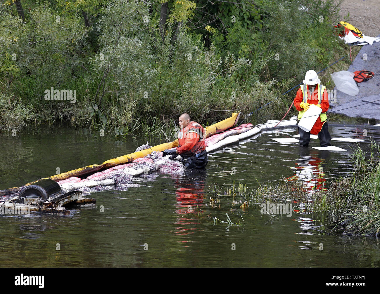 Crews work to clean up the Kalamazoo River near Battle Creek, Michigan on July 30, 2010. A 30-inch-diameter pipeline ruptured sometime between Sunday night and Monday morning, sending between 800,000 and 1 million gallons of oil into nearby Talmadge Creek and the Kalamazoo River.     UPI/Brian Kersey Stock Photo