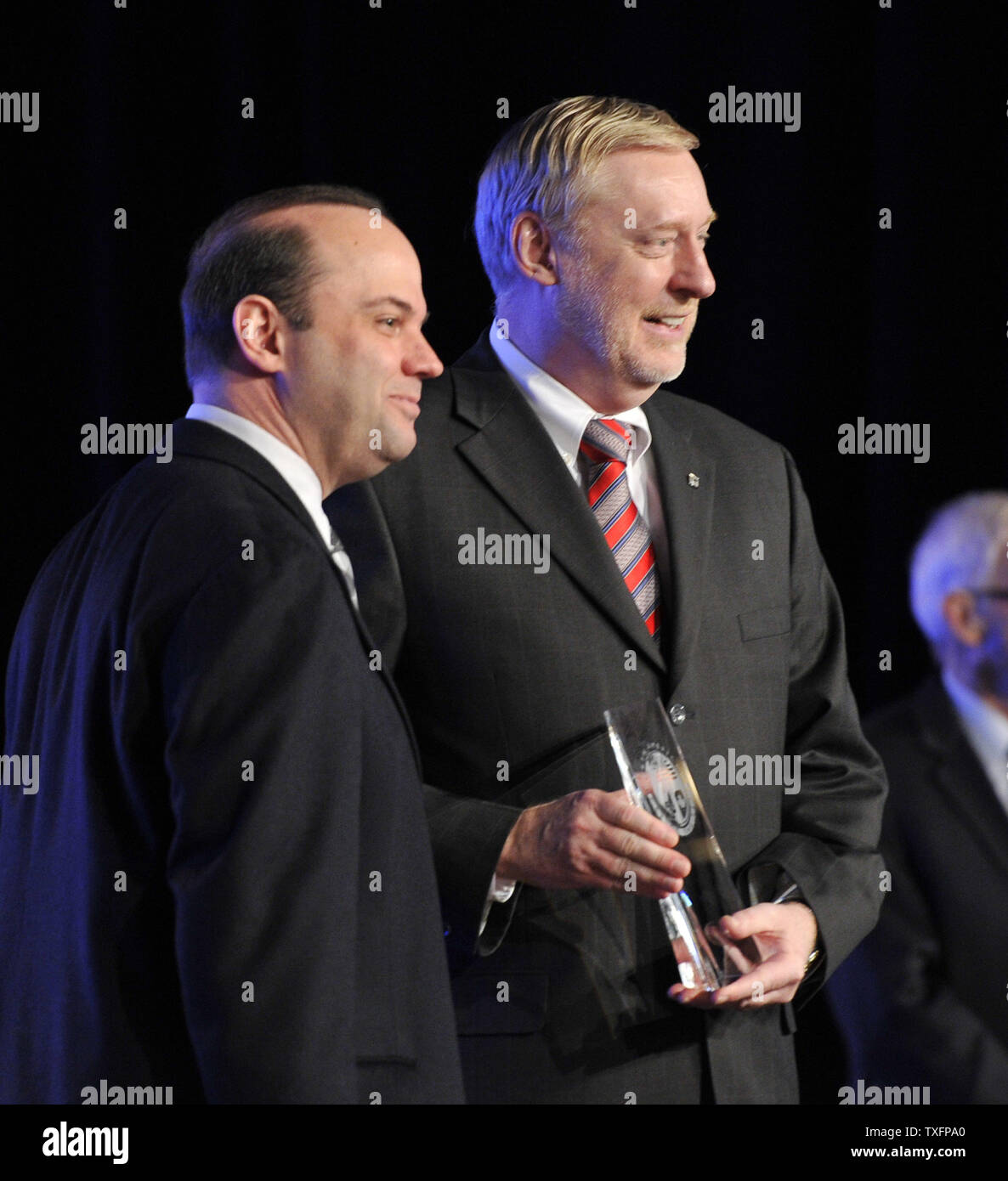 Tom Stevens (L) vice chairman of General Motors Global Product Operation, receives the 2011 North American Car-of-the-Year award from Edmunds editor-in-cheif Karl Brauer at the 2011 North American International Auto Show at the Cobo Center in Detroit on January 10, 2011. The 2011 Chevrolet Volt won the award.     UPI/Brian Kersey Stock Photo