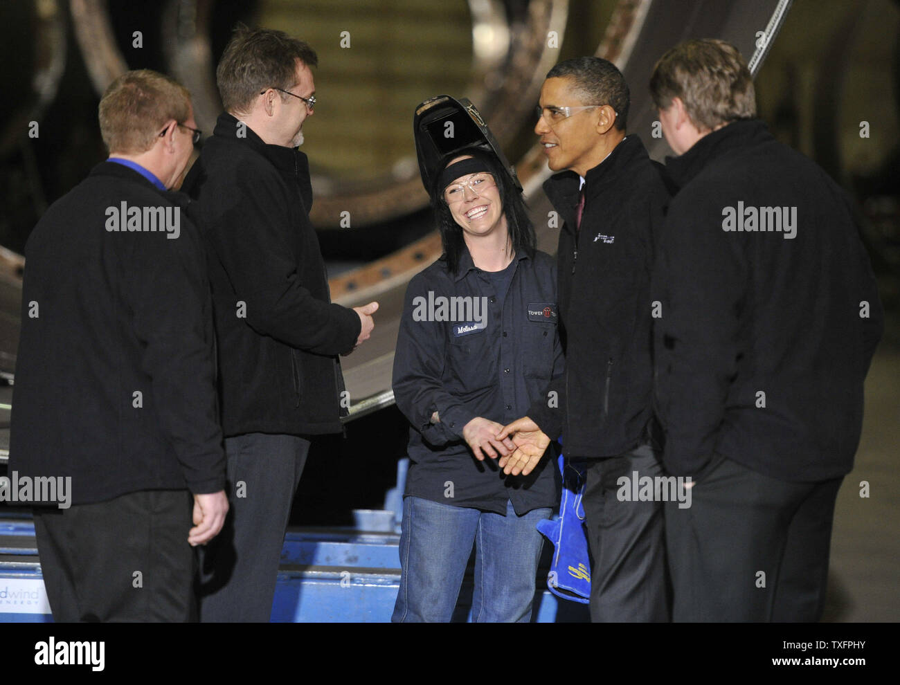 U. S. President Barack Obama (center right) shakes hands with Melissa Peters (C) as he tours Tower Tech Systems, Inc., a manufacturer of utility-scale wind towers and monopiles for on- and off-shore wind development,  with executive Paul Smith (center left) and other executives in Manitowoc, Wisconsin on January 26, 2011. President Obama, Vice President Joe Biden and other members of the President's Cabinet traveled across the country Wednesday to highlight the administration's efforts to rebuild the American economy.      UPI/Brian Kersey Stock Photo
