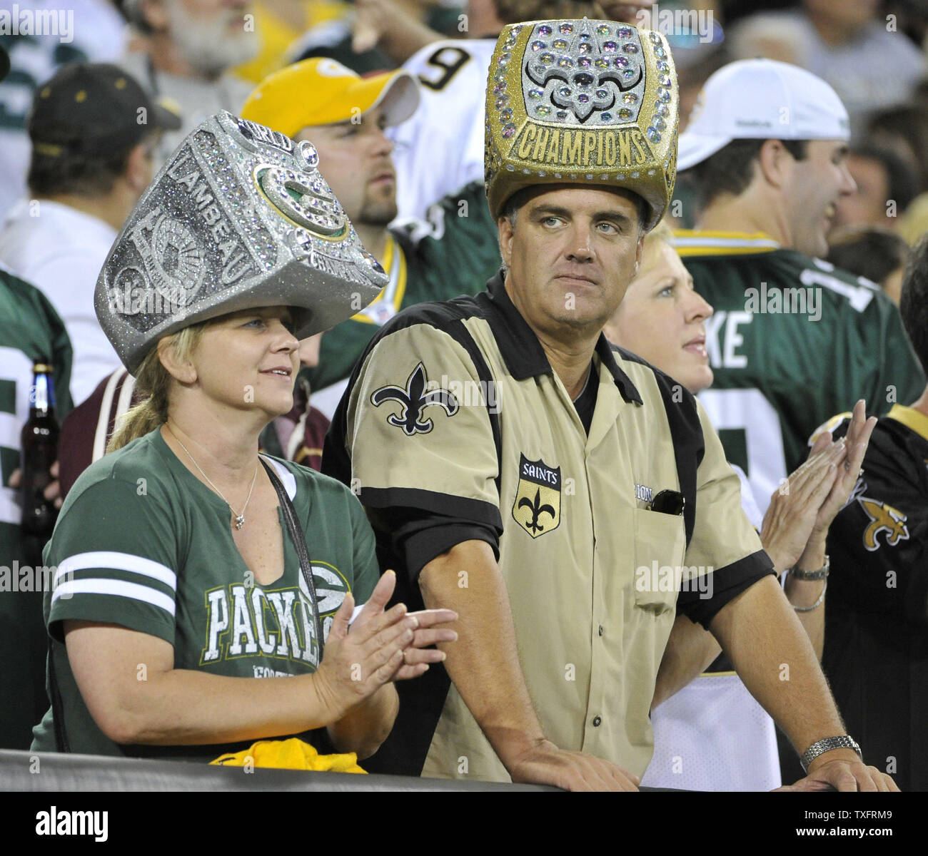 A Green Bay Packers fan (L) and a New Orleans Saints fan both wear Super  Bowl ring hats during the second quarter of the Saints Packers game at  Lambeau Field on September