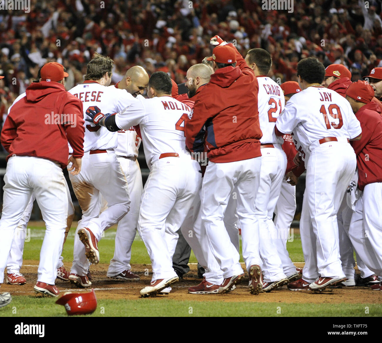 The St. Louis Cardinals mob teammate David Freese at home plate after he hit a game-winning solo home run during the 11th inning of game 6 of the World Series against the Texas Rangers at Busch Stadium on October 27, 2011 in St. Louis. The Cardinals won 10-9 in 11 innings tying the series 3-3.     UPI/Brian Kersey Stock Photo