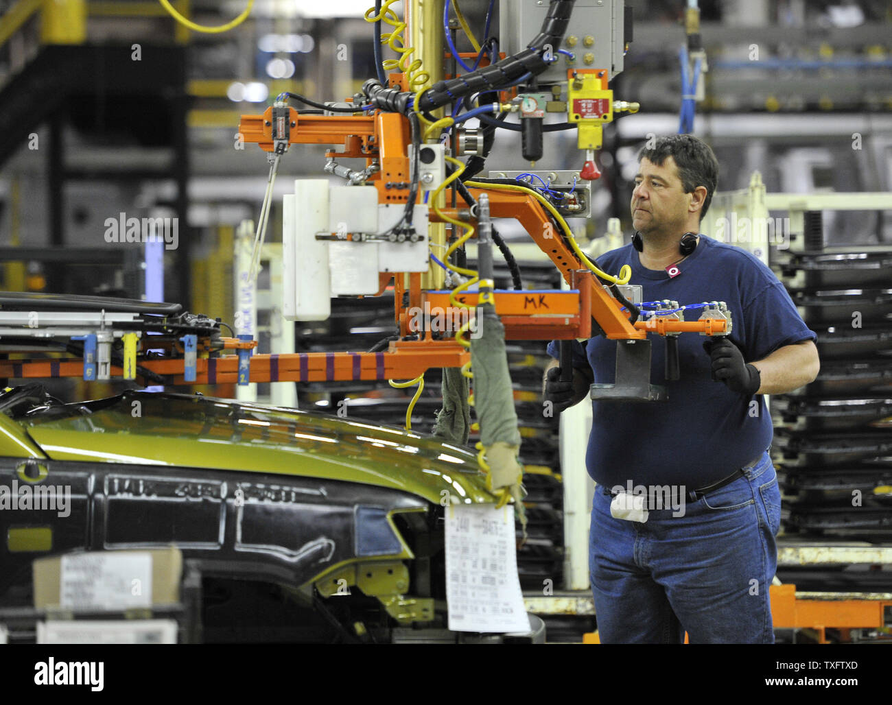A worker installs a sunroof assembly on a car at Chrysler's Belvidere