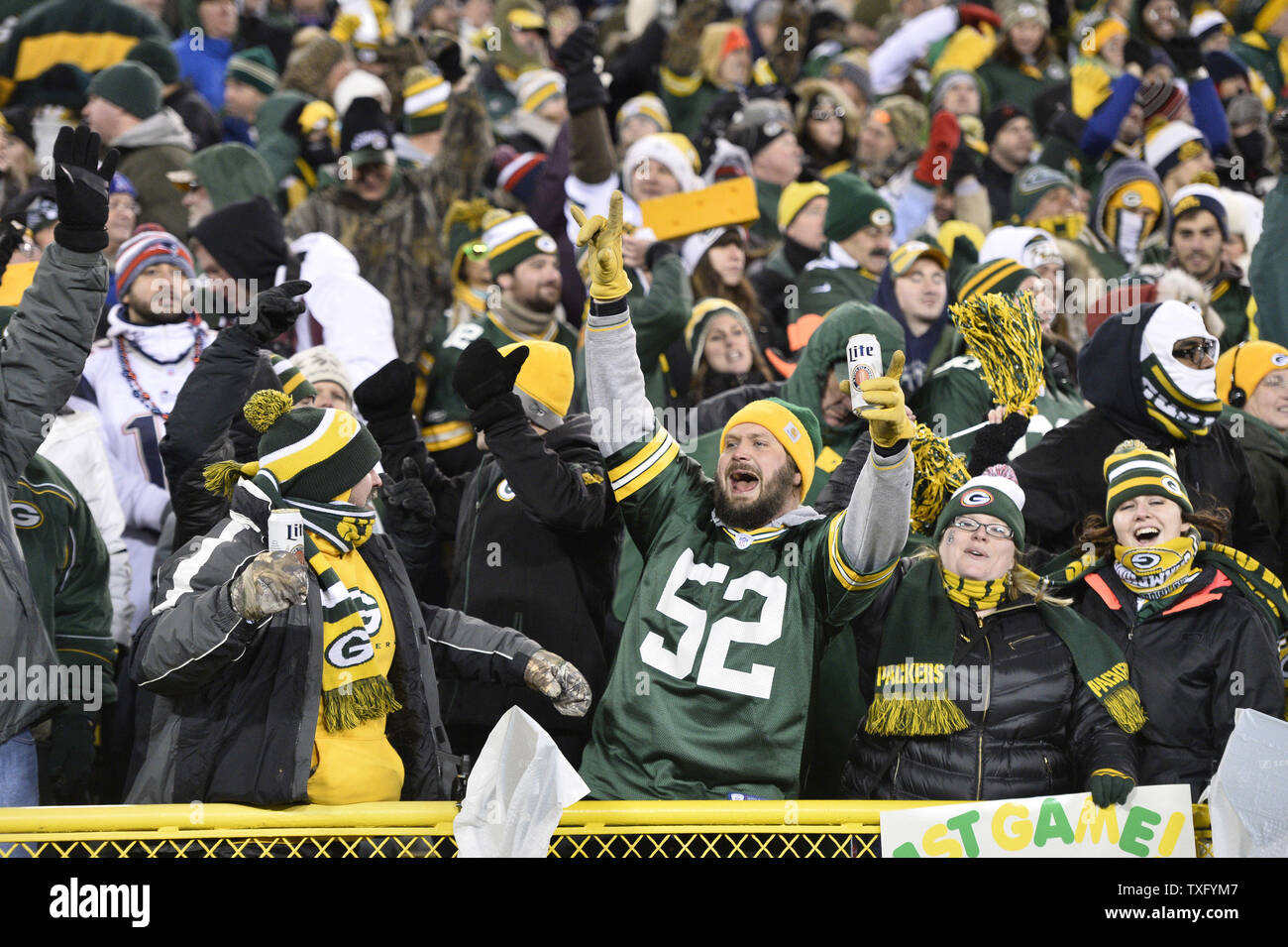 Green Bay Packers fans celebrate after the Packers got a first down with two minutes left in the fourth quarter to ice the game against the New England Patriots at Lambeau Field on November 30, 2014 in Green Bay, Wisconsin. The Packers defeated the Patriots 26-21.     UPI/Brian Kersey Stock Photo