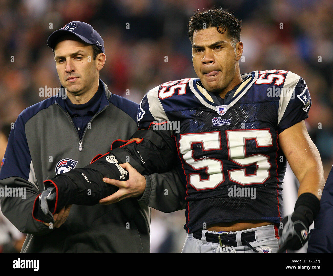 New England Patriots linebacker Junior Seau walks off the field after  suffering a broken arm while making a tackle in the second quarter against  the Chicago Bears at Gillette Stadium in Foxboro,