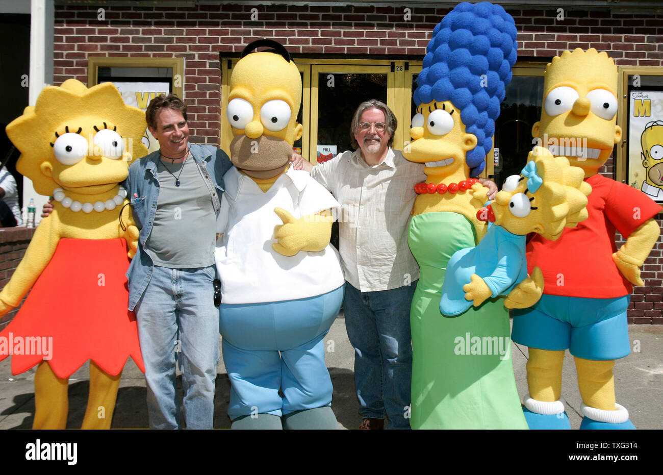 'The Simpsons Movie' director David Silverman (2nd L) stands with producer Matt Groening (C) and the characters from the movie at the hometown premier of 'The Simpsons Movie' at the Springfield Movie Theater in Springfield, Vermont on July 21, 2007.  From left are Lisa Simpson, David Silverman, Homer Simpson, Matt Groening, Marge Simpson, Maggie Simson, and Bart Simpson. (UPI Photo/Matthew Healey) Stock Photo