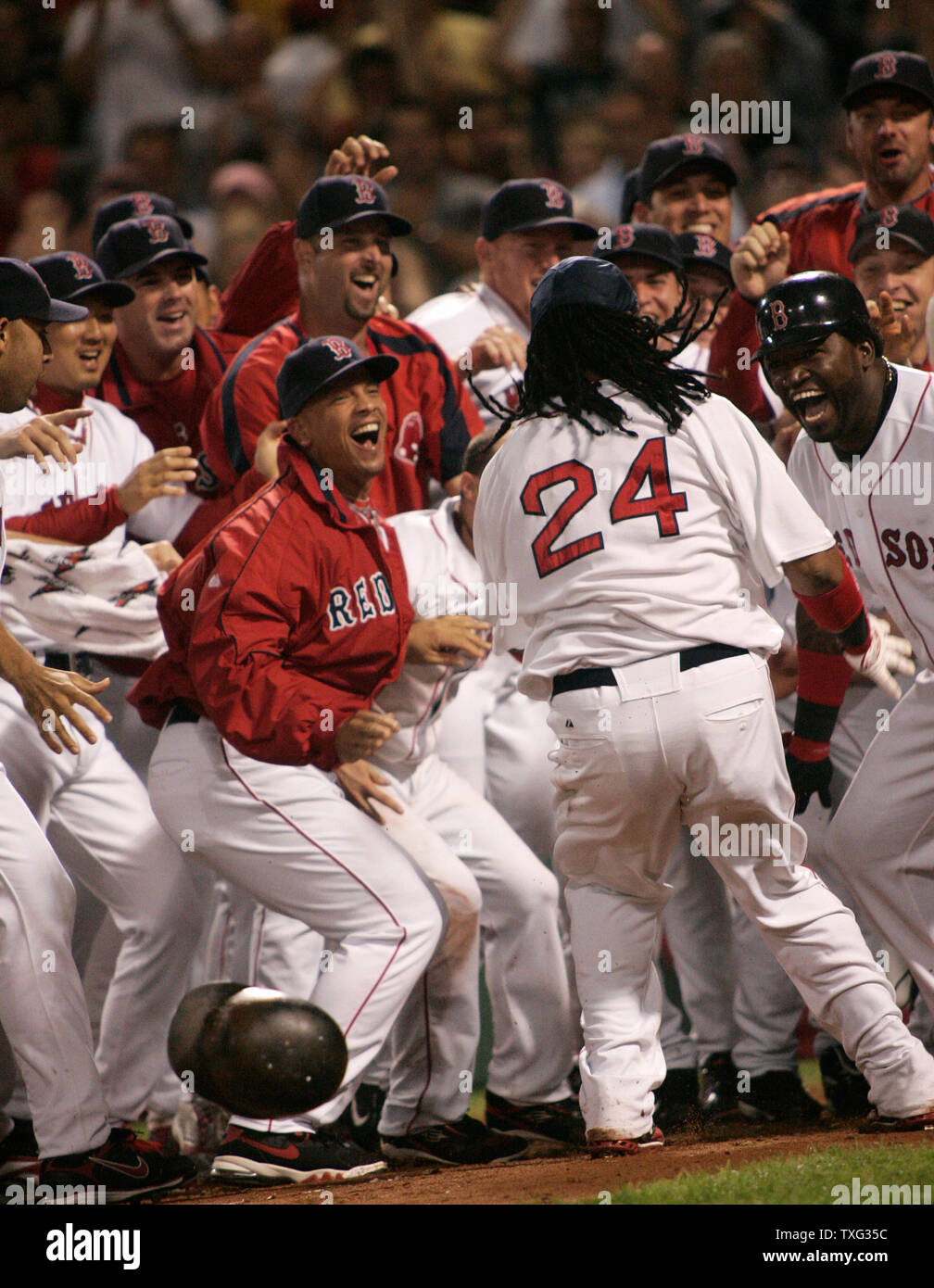 The Boston Red Sox cheer from home plate as runner Manny Ramirez