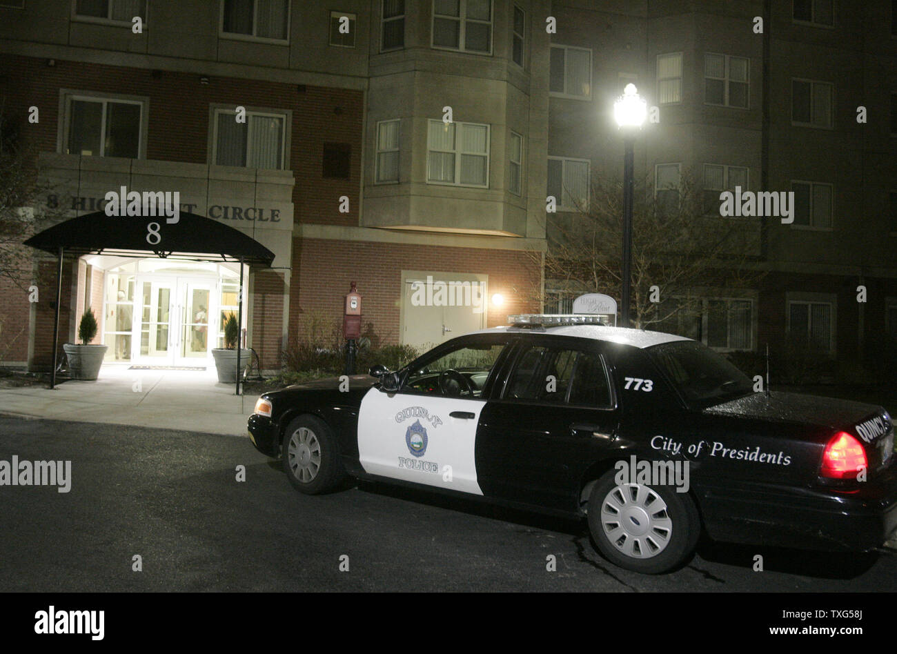 A Quincy police patrol car is parked in front of the entrance to the