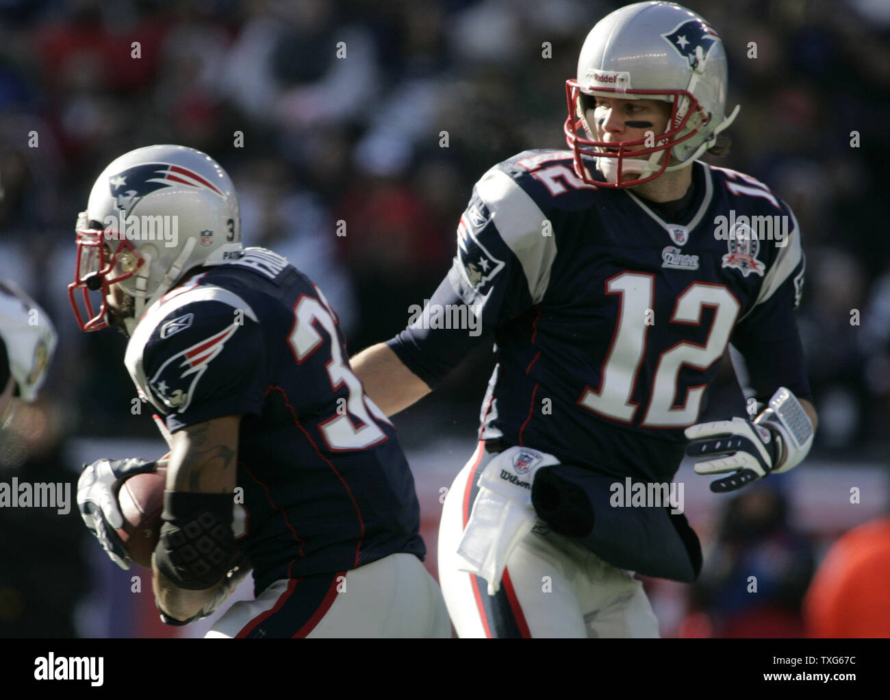 New England Patriots quarterback Tom Brady (12) hands off to Kevin Faulk (33) in the first quarter of the AFC Wildcard game against the New England Patriots at Gillette Stadium in Foxboro, Massachusetts on January 10, 2010.    UPI/Matthew Healey Stock Photo