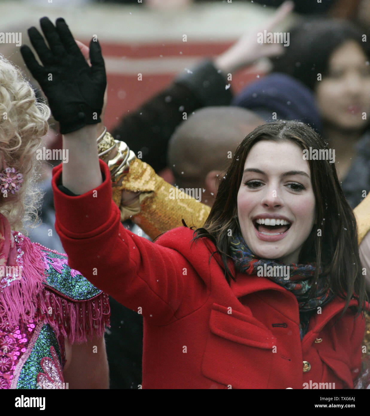 Actress Anne Hathaway waves to the spectators during the Harvard