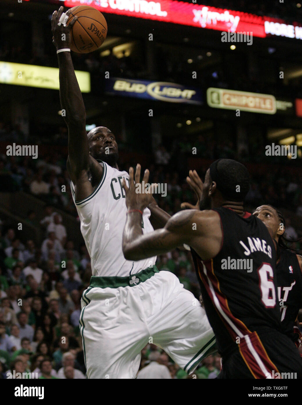Boston Celtics forward Kevin Garnett gets off a shot past Miami Heat forward LeBron James (6) and Udonis Haslem in the first half of the opening night game at the TD Garden in Boston, Massachusetts on October 26, 2010.   UPI/Matthew Healey Stock Photo