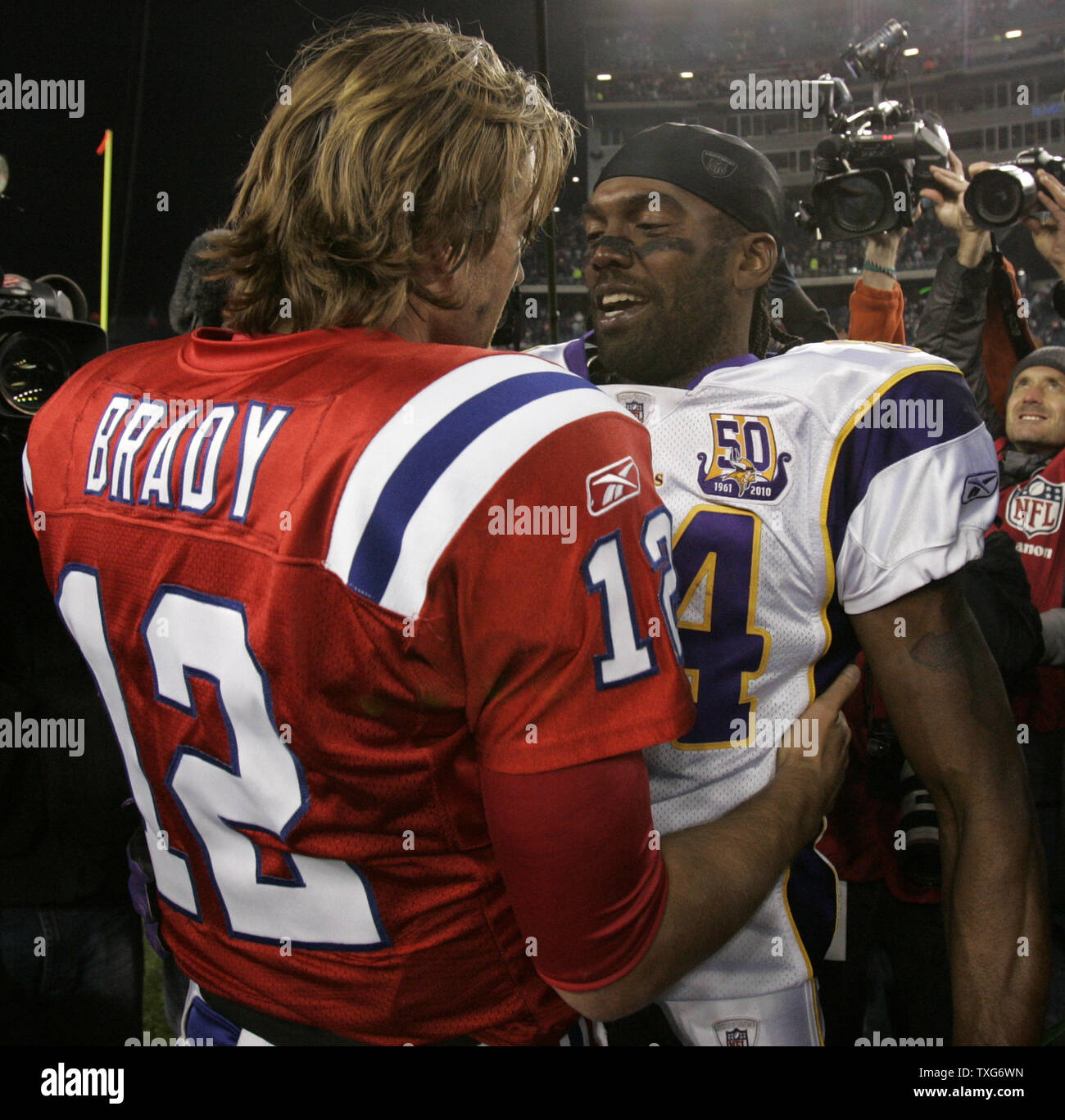 Minnesota Vikings wide receiver Randy Moss gives a hug to his former  teammate, New England Patriots quarterback Tom Brady at the end of the game  at Gillette Stadium in Foxboro, Massachusetts on