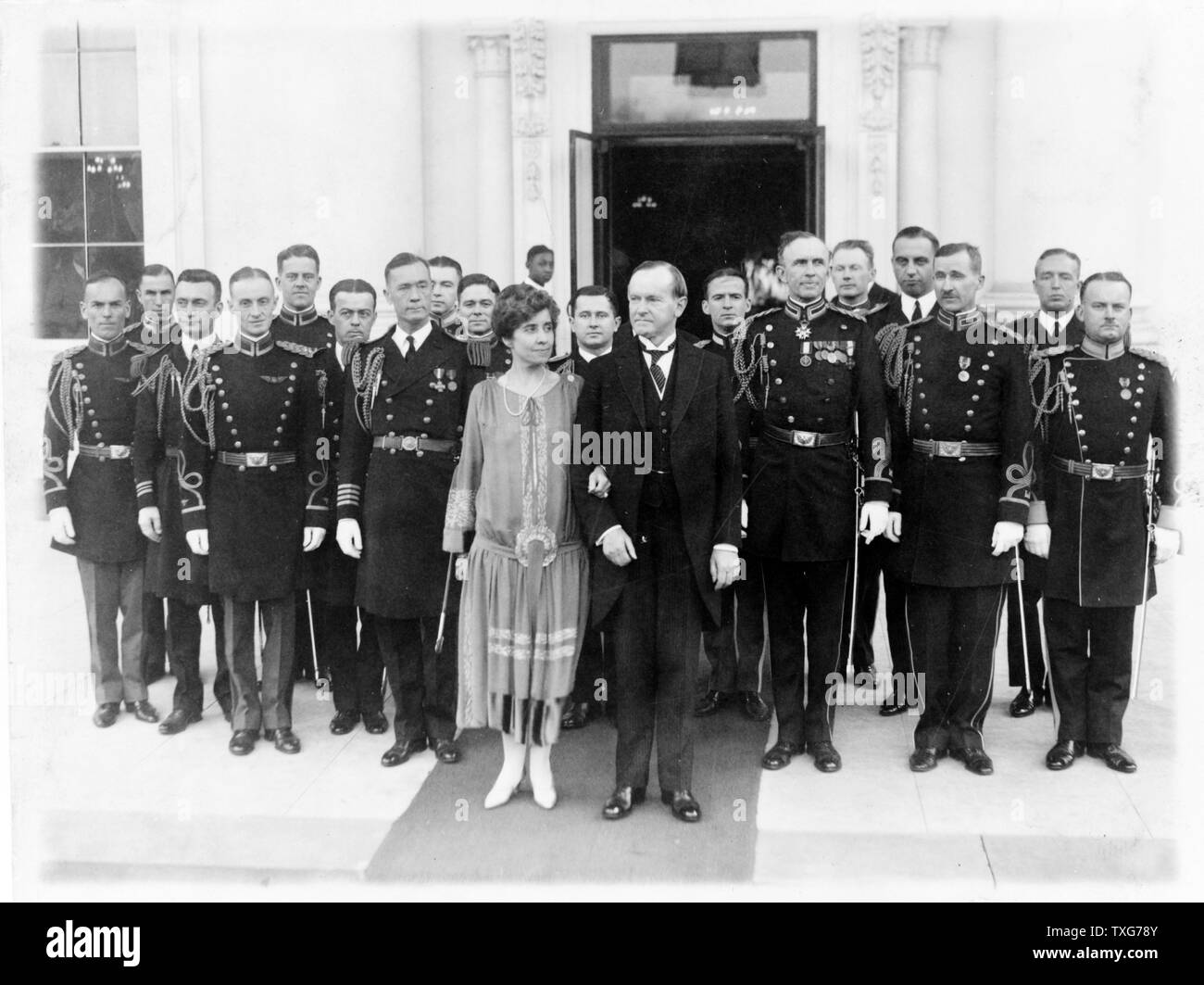 John Calvin Coolidge, 30th President of the USA (1923-1929). President and Mrs Coolidge with military aides outside the White House on l January 1927 after a New Year reception Stock Photo