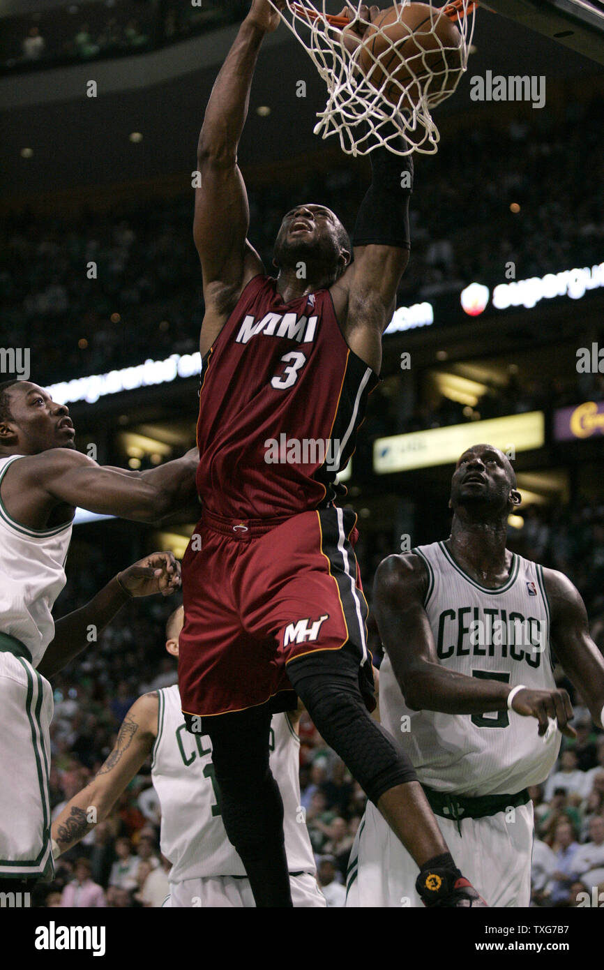 Miami Heat guard Dwyane Wade (3) dunks on Boston Celtics forward Jeff Green (L) and forward Kevin Garnett in the second quarter of the Eastern Conference Semifinals at the TD Garden in Boston, Massachusetts on May 7, 2011.   UPI/Matthew Healey Stock Photo