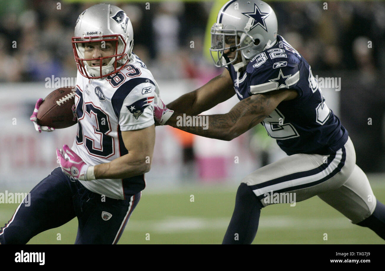 New England Patriots wide receiver Wes Welker (83) is pushed out of bounds  by Dallas Cowboys cornerback Orlando Scandrick (32) after a ten yard  reception in the fourth quarter at Gillette Stadium