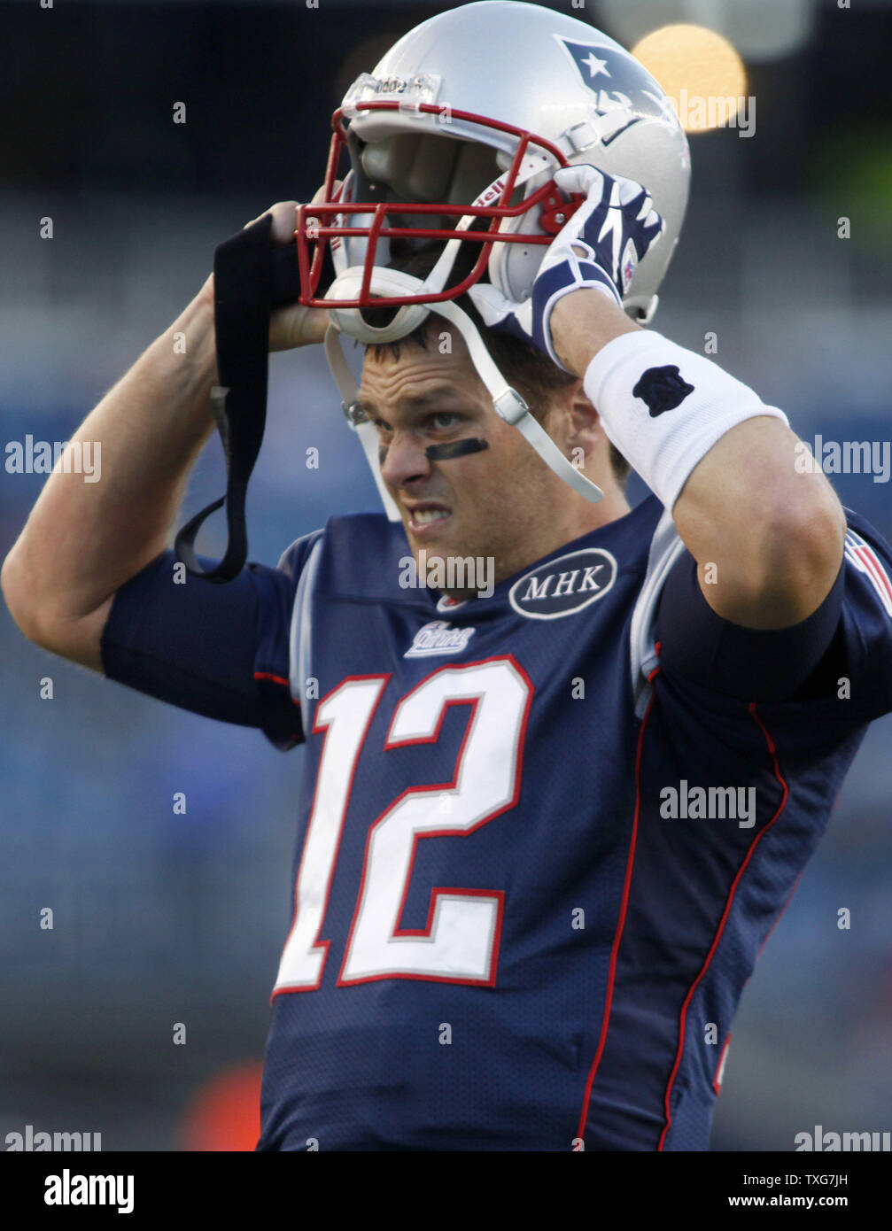 New England Patriots quarterback Tom Brady puts on his helmet while warming up with his team before taking on the New York Giants at Gillette Stadium in Foxboro, Massachusetts on November 6, 2011.    UPI/Matthew Healey Stock Photo