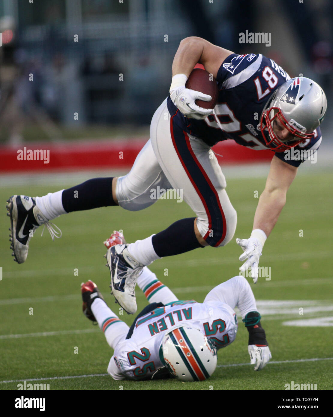 New England Patriots tight end Rob Gronkowski 87 is tripped up by Miami Dolphins cornerback Will Allen 25 on a 9 yard reception in the fourth quarter at Gillette Stadium in Foxboro Massachusetts