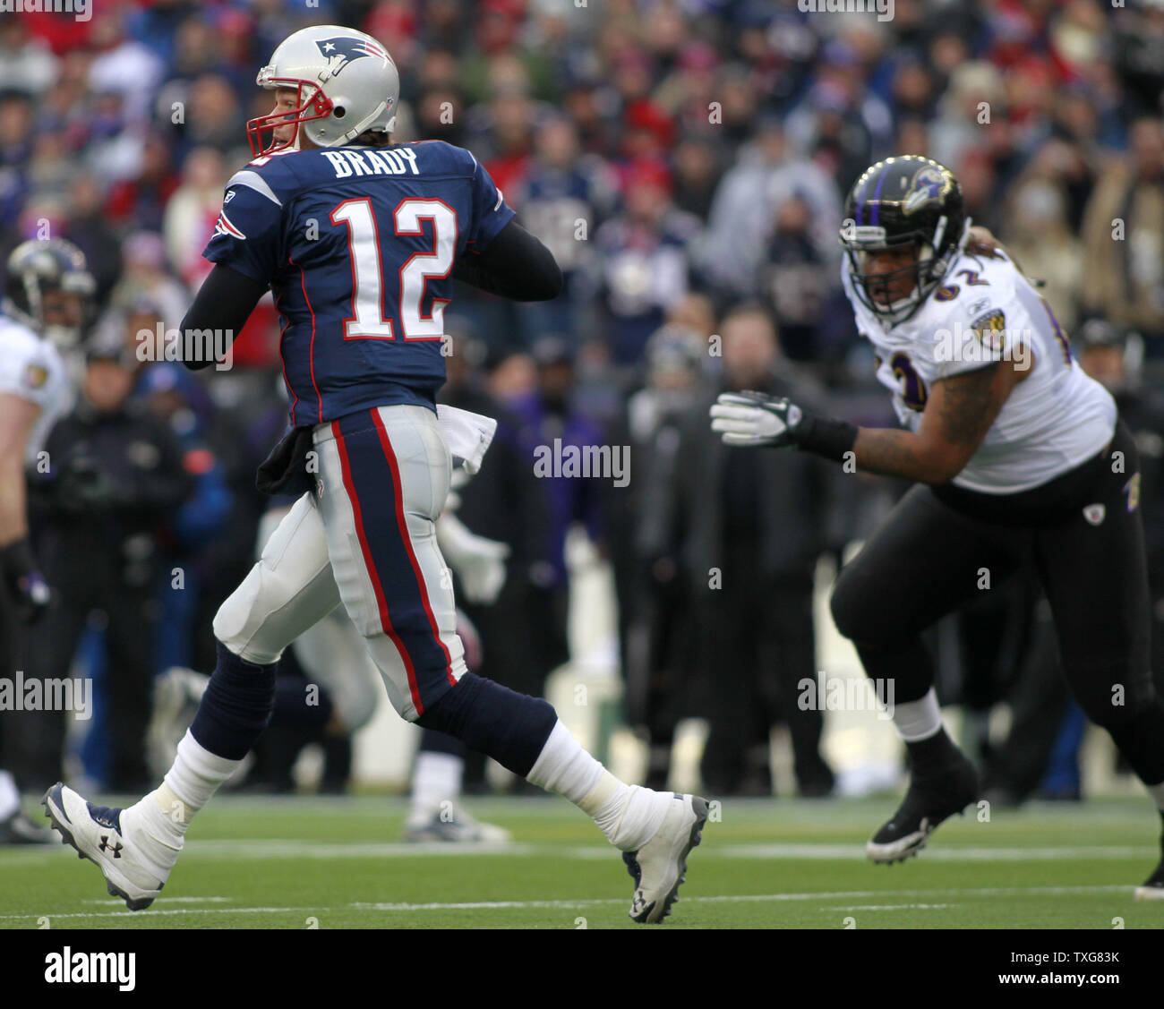 New England Patriots quarterback Tom Brady (12) scrambles from Baltimore Ravens nose tackle Terrence Cody (62) in the first quarter of the AFC Championship at Gillette Stadium in Foxboro, Massachusetts on January 22, 2012.   UPI/Matthew Healey Stock Photo