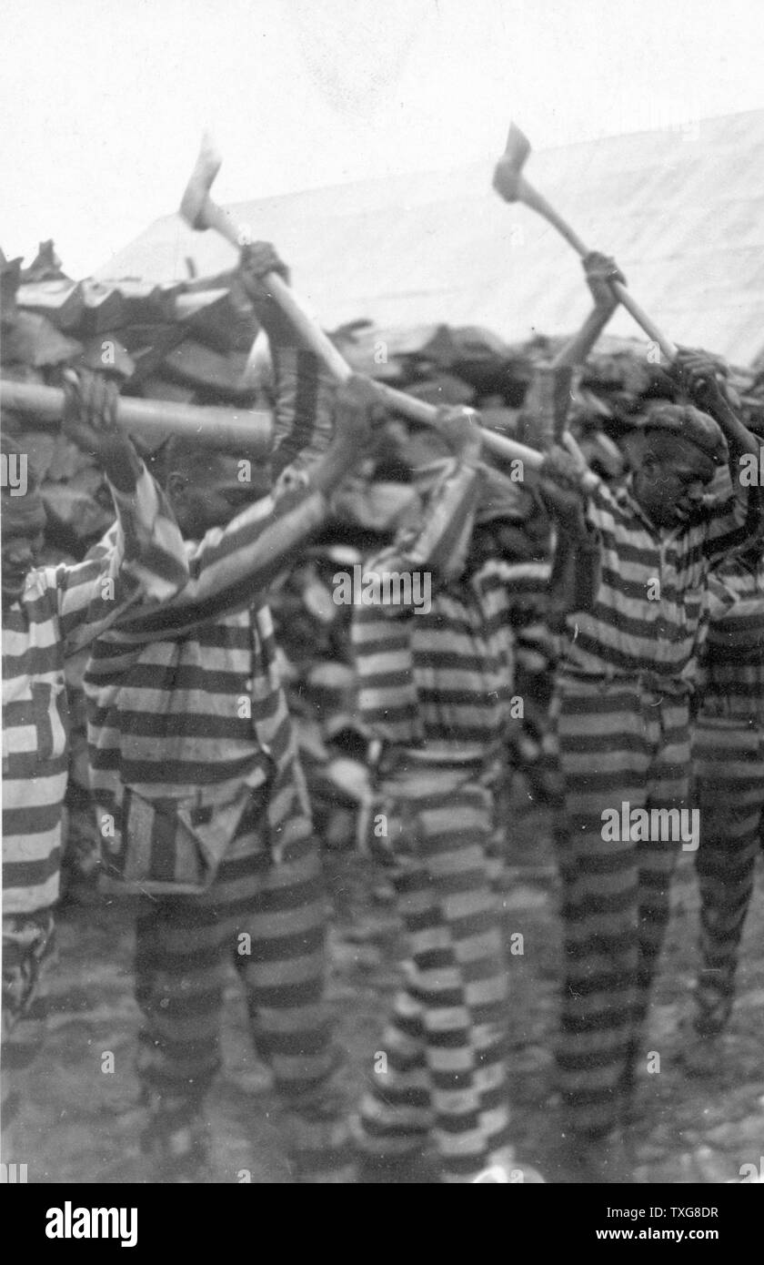 African-American convicts at Reed Camp, South Carolina, working with axes and singing Stock Photo