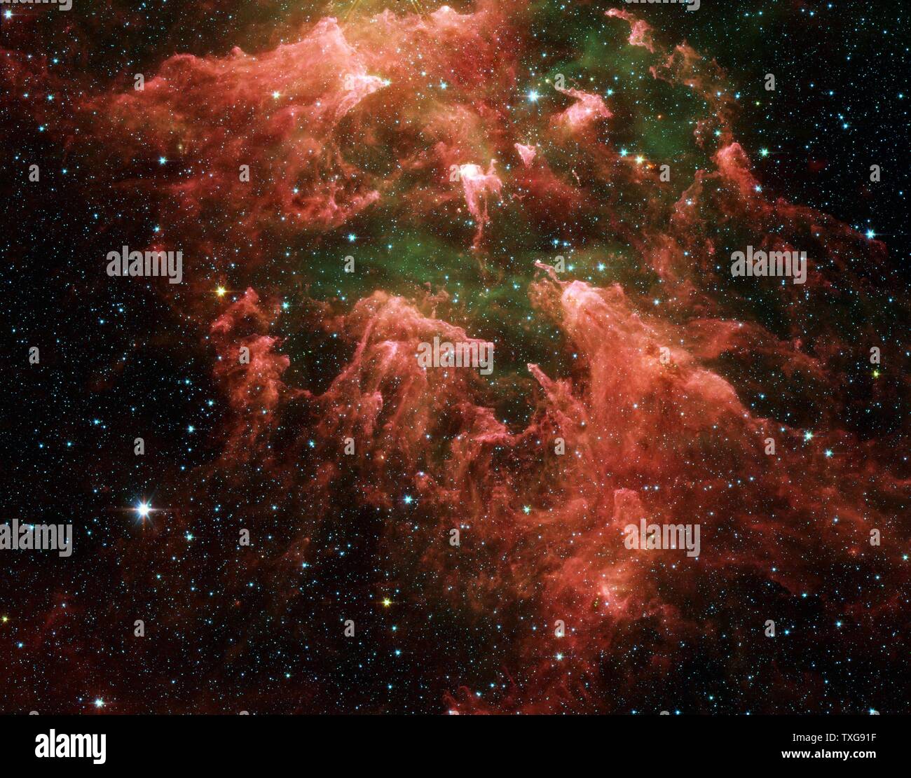 Spitzer Space Telescope false-colour image star-forming region in the Carina Nebula. Star embryos (yellow or white) inside thick dust layers (pink) Hot gases are green Credit NASA Stock Photo
