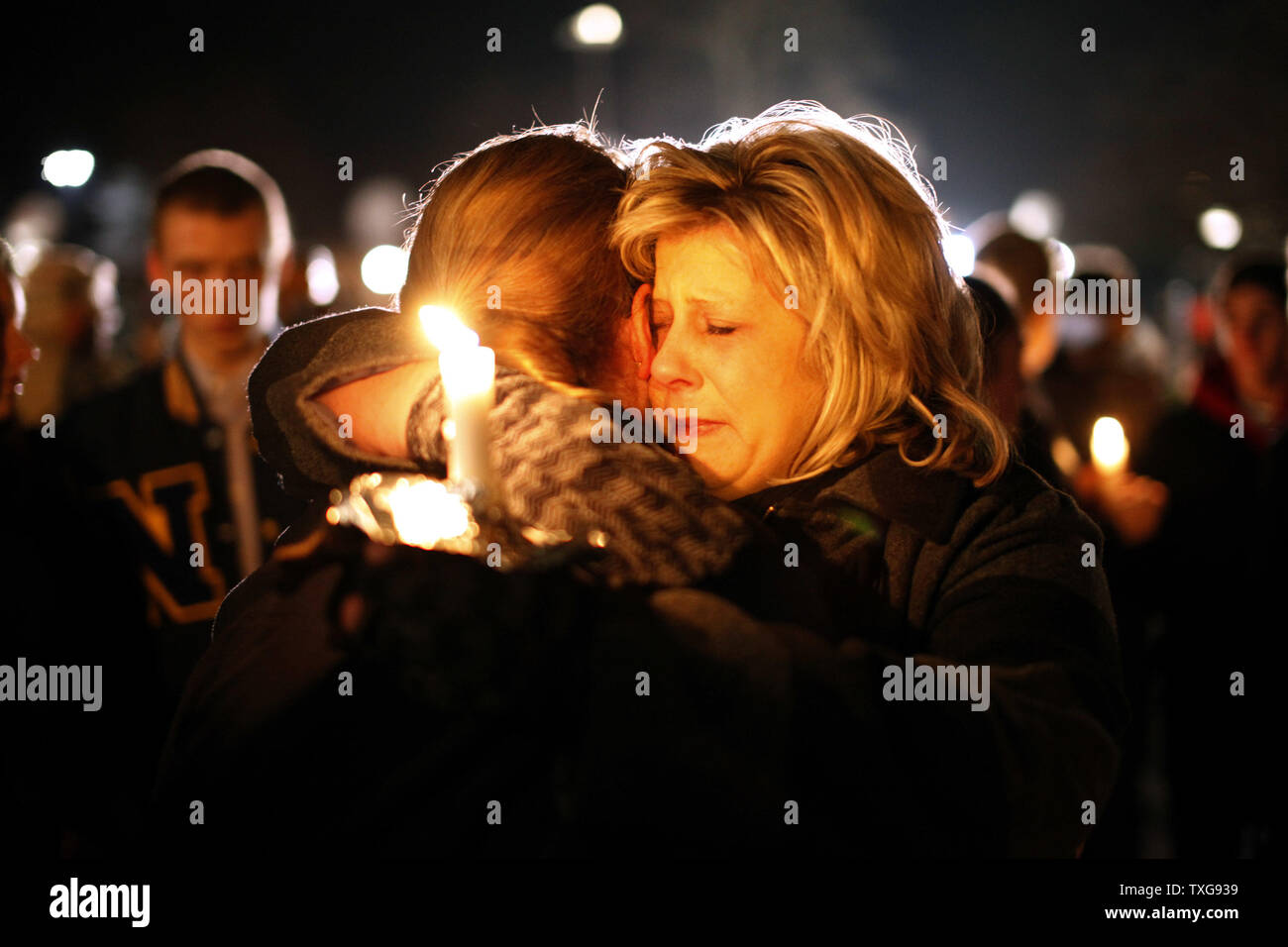 Two women hug outside of Saint Rose of Lima Catholic Church in Newtown, Connecticut during a prayer service and vigil in response to a shooting that left at least 26 people dead including 18 children at the Sandy Hook School earlier in the day on December 14, 2012.  A gunman opened fire inside inside Sandy Hook Elementary School early Friday morning where his mother worked.  The suspect 20-year-old Adam Lanza, reportedly killed himself following the shooting rampage inside the school.  UPI/Matt Healey Stock Photo
