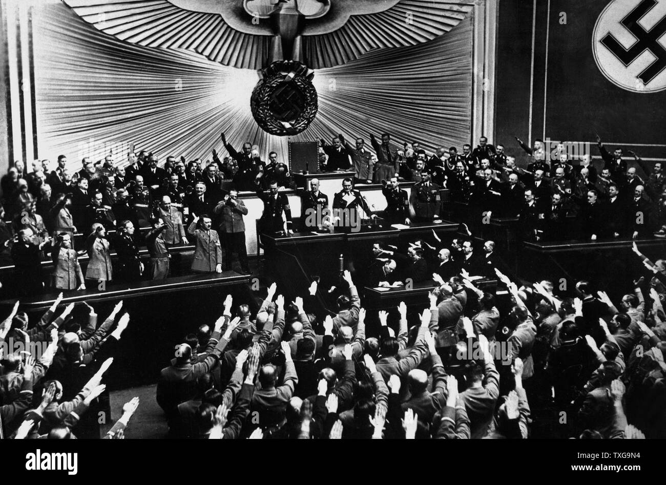 Adolf Hitler receiving an ovation in the Reichstag after announcing the peaceful acquisition of Austria. Berlin, March 1938 Stock Photo