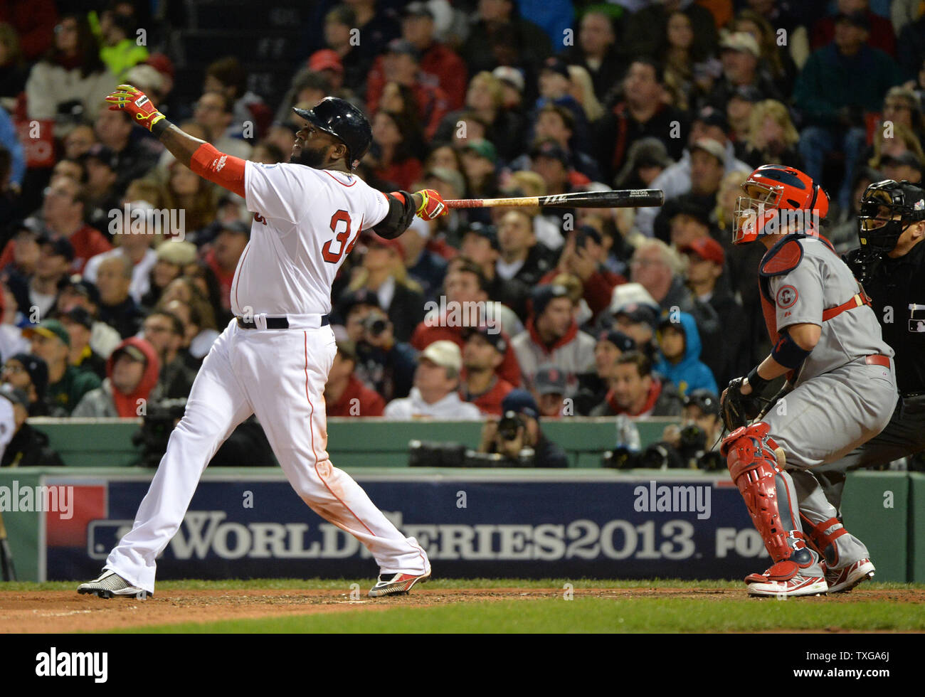 Boston Red Sox David Ortiz (L) watches the flight of his two run